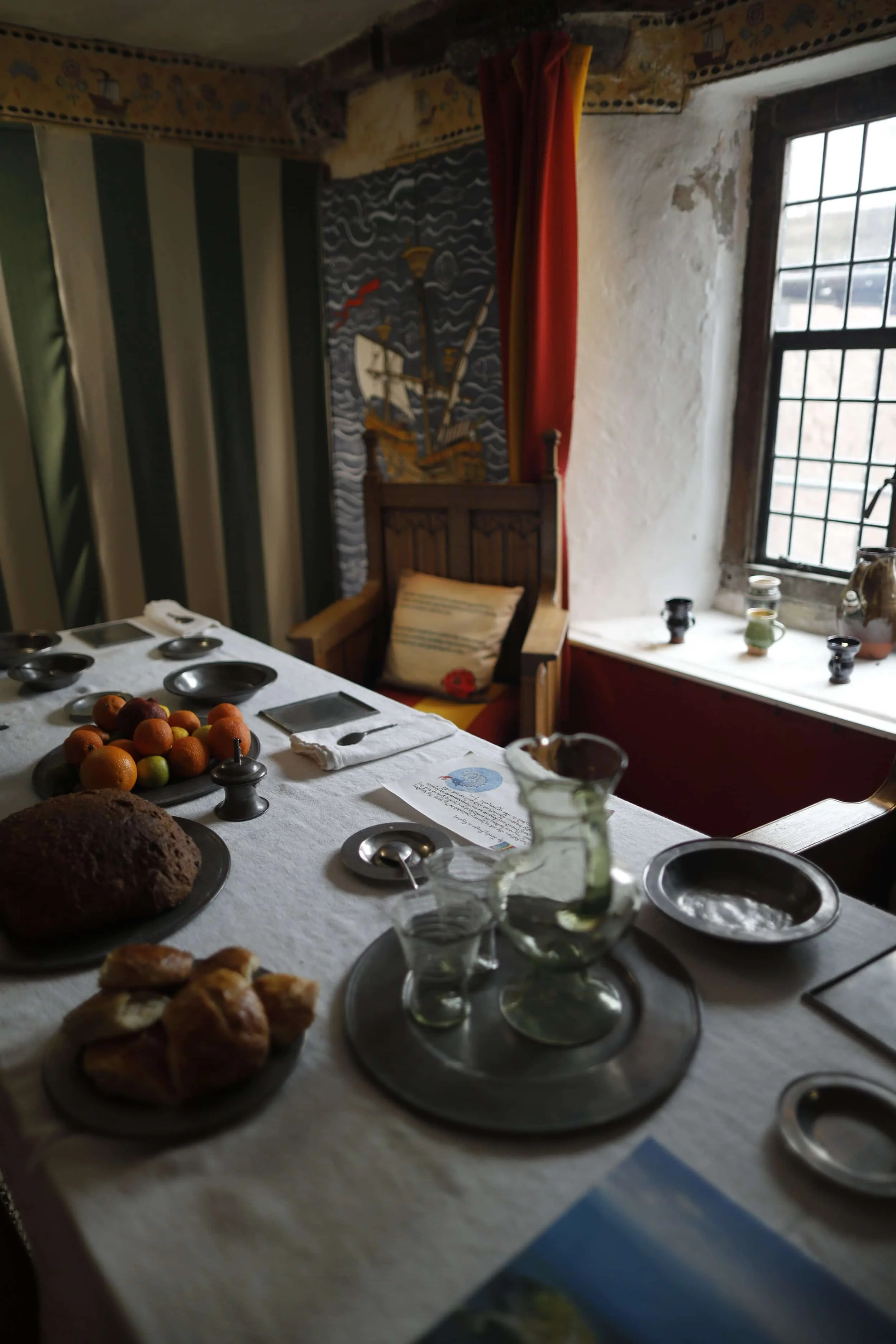 Views of a dining table with food at the Tudor Merchant's House in Tenby Wales