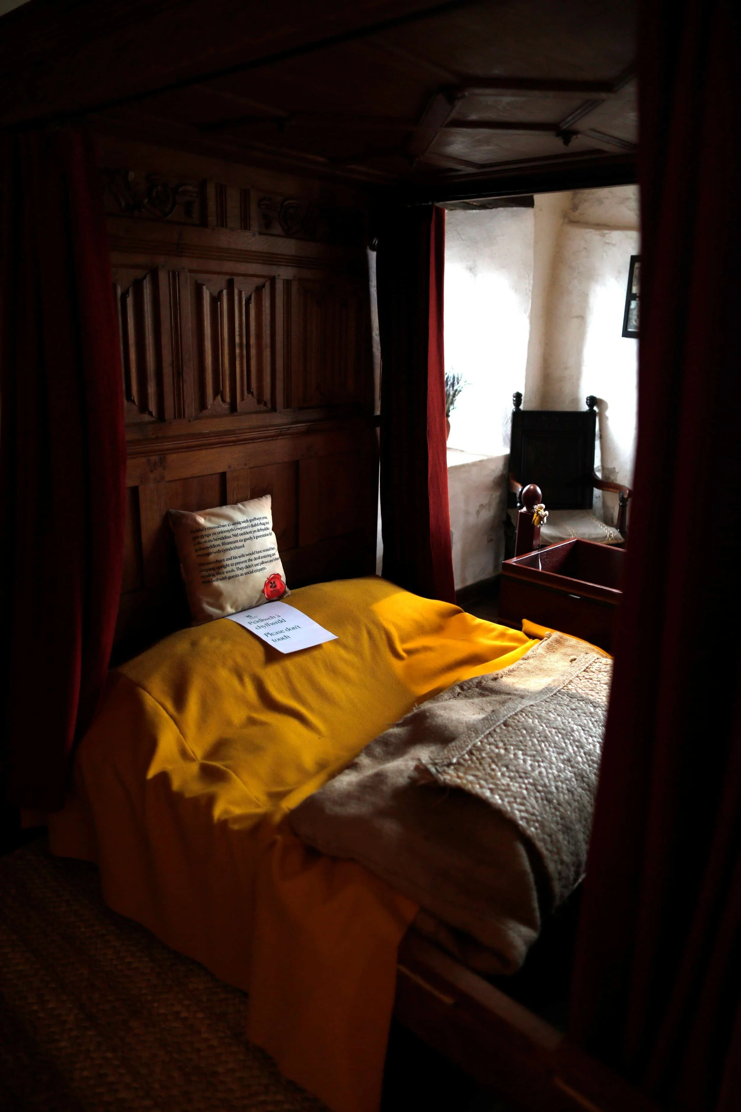 Bedroom with bed at the Tudor Merchant's House in Tenby Wales
