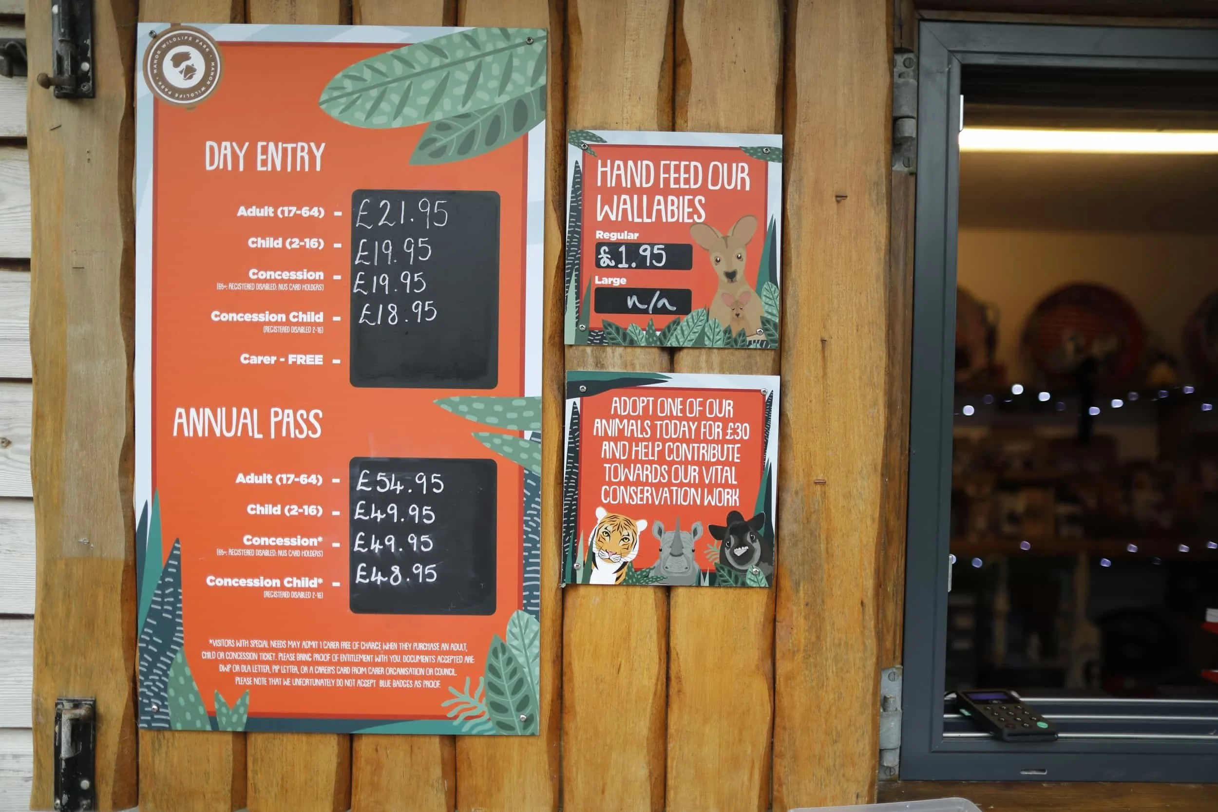 Signage listing off prices for feeding wallabies at Manor Wildlife Park near Tenby Wales