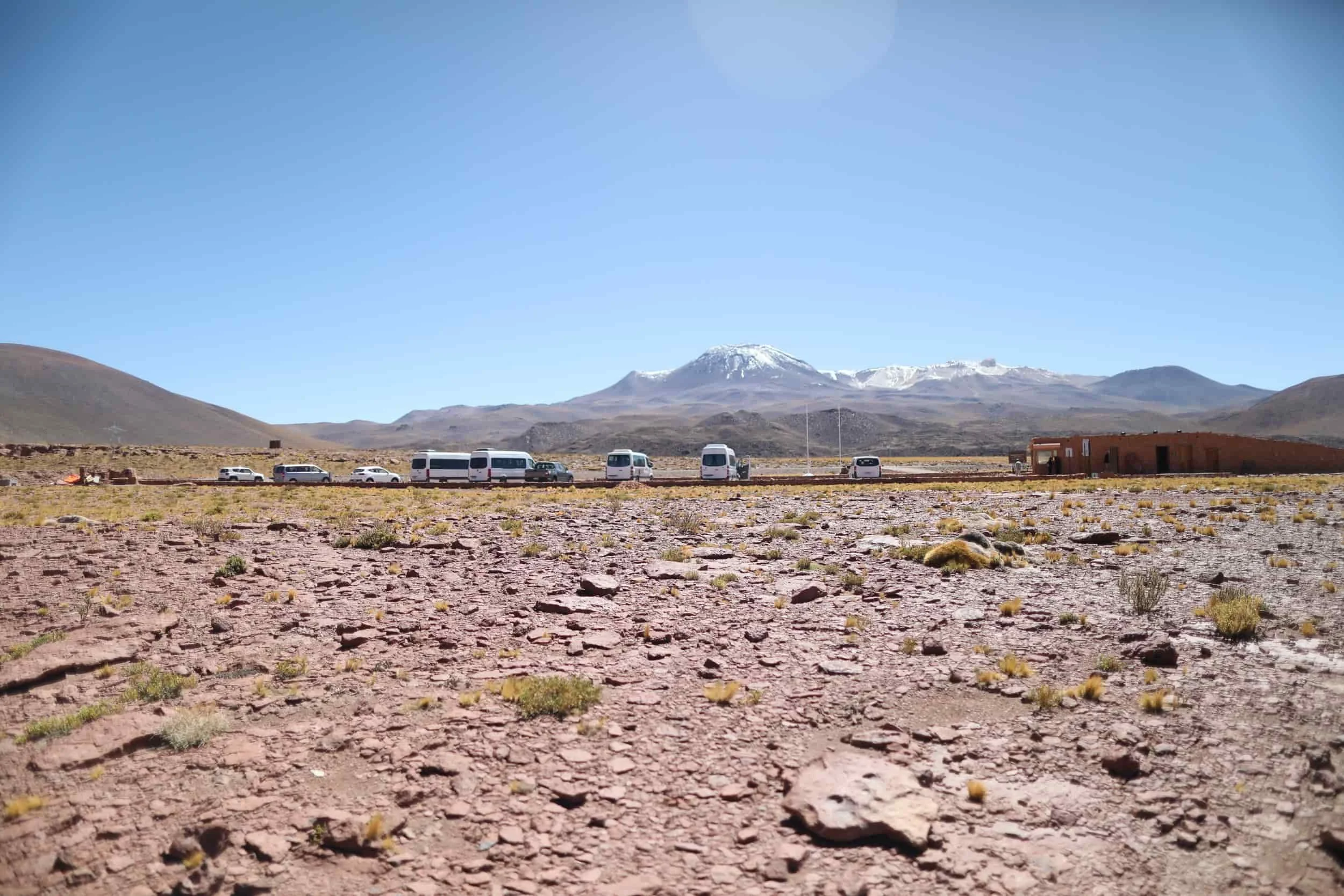 Desert with red rocks and mountains in the distance at Piedras Rojas in Atacama Desert in Chile