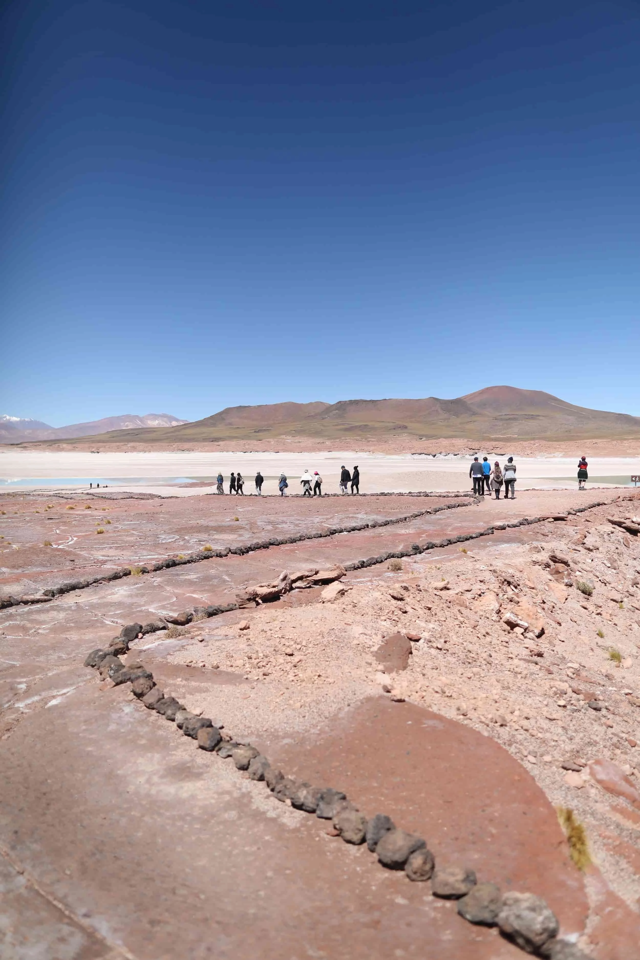 Desert with red rocks and mountains in the distance at Piedras Rojas in Atacama Desert in Chile