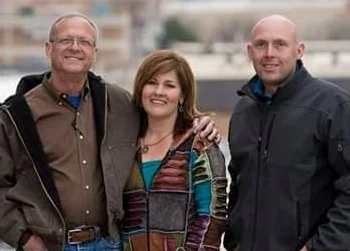 Bob and Marcy Brown stand with VP of Operations Chris Comeau at the site of another of their projects. See this project at www.hdleetowers.com .