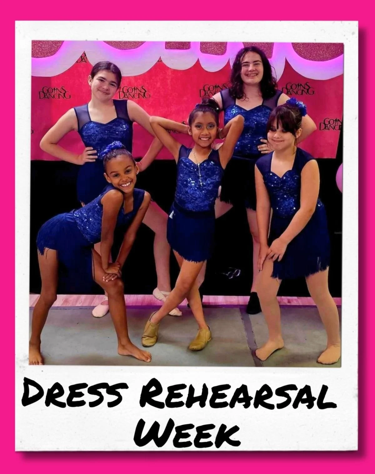 Five dancers pose together wearing royal blue dance costumes.