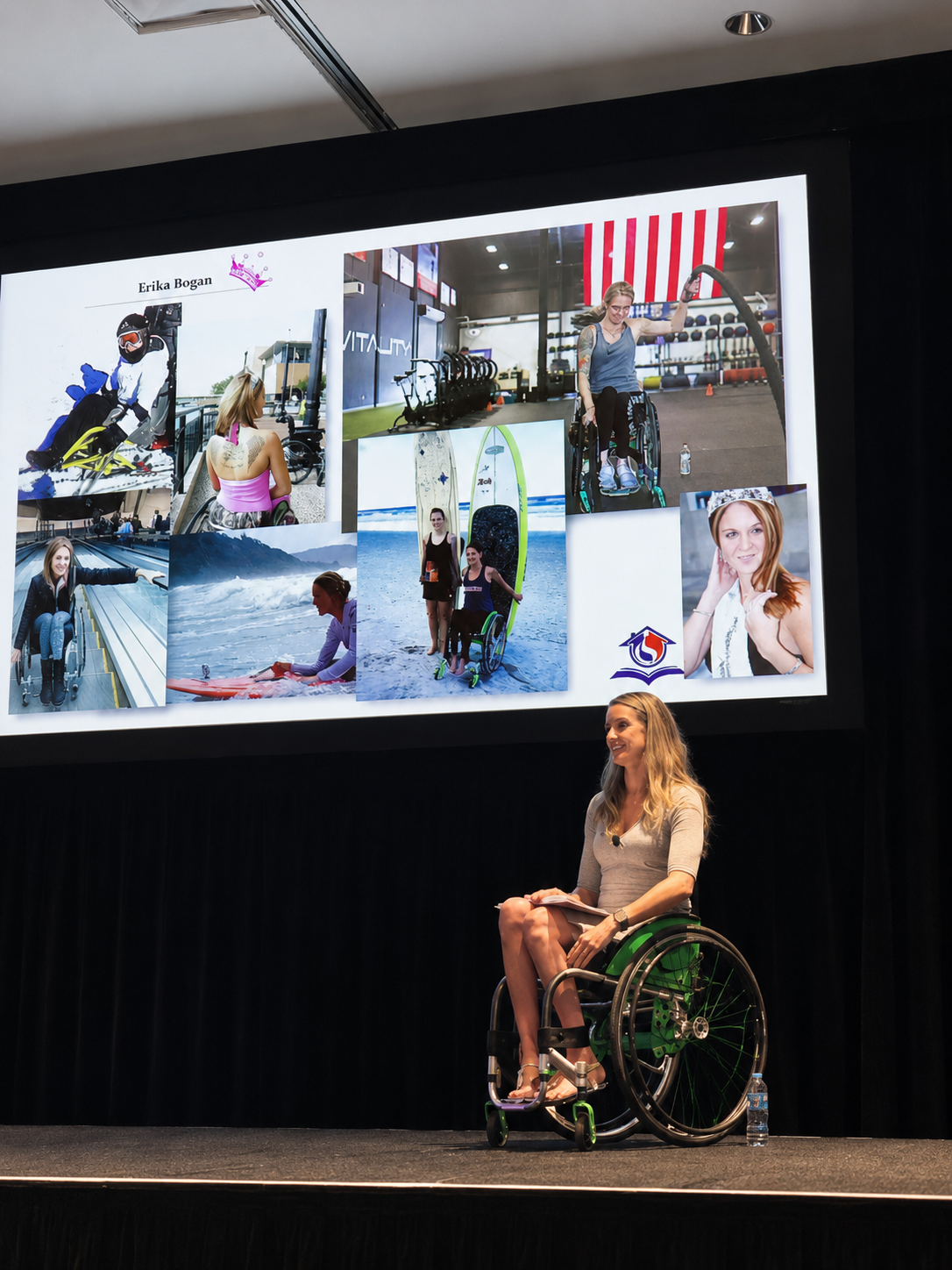 Woman in wheelchair giving presentation on stage with a large screen displaying photos of her engaging in various activities, including wheelchair sports, at a gym, and at the beach.