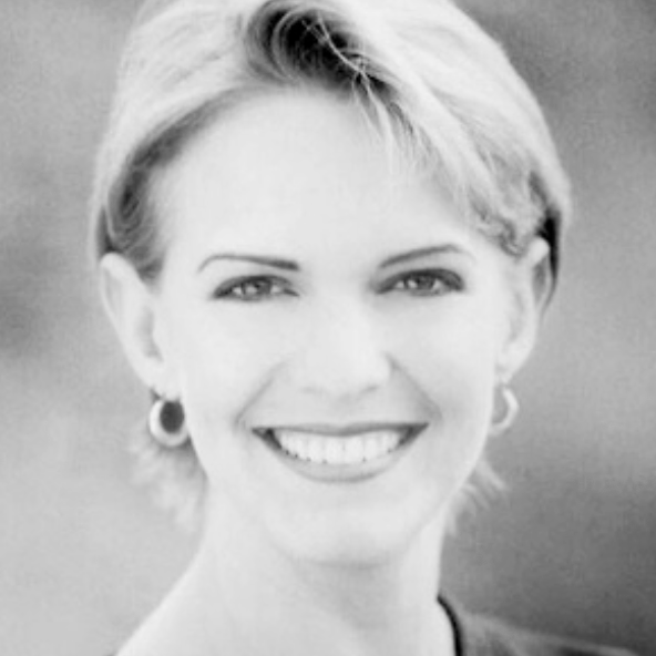 Black and white portrait of a woman with short hair, smiling, wearing hoop earrings.