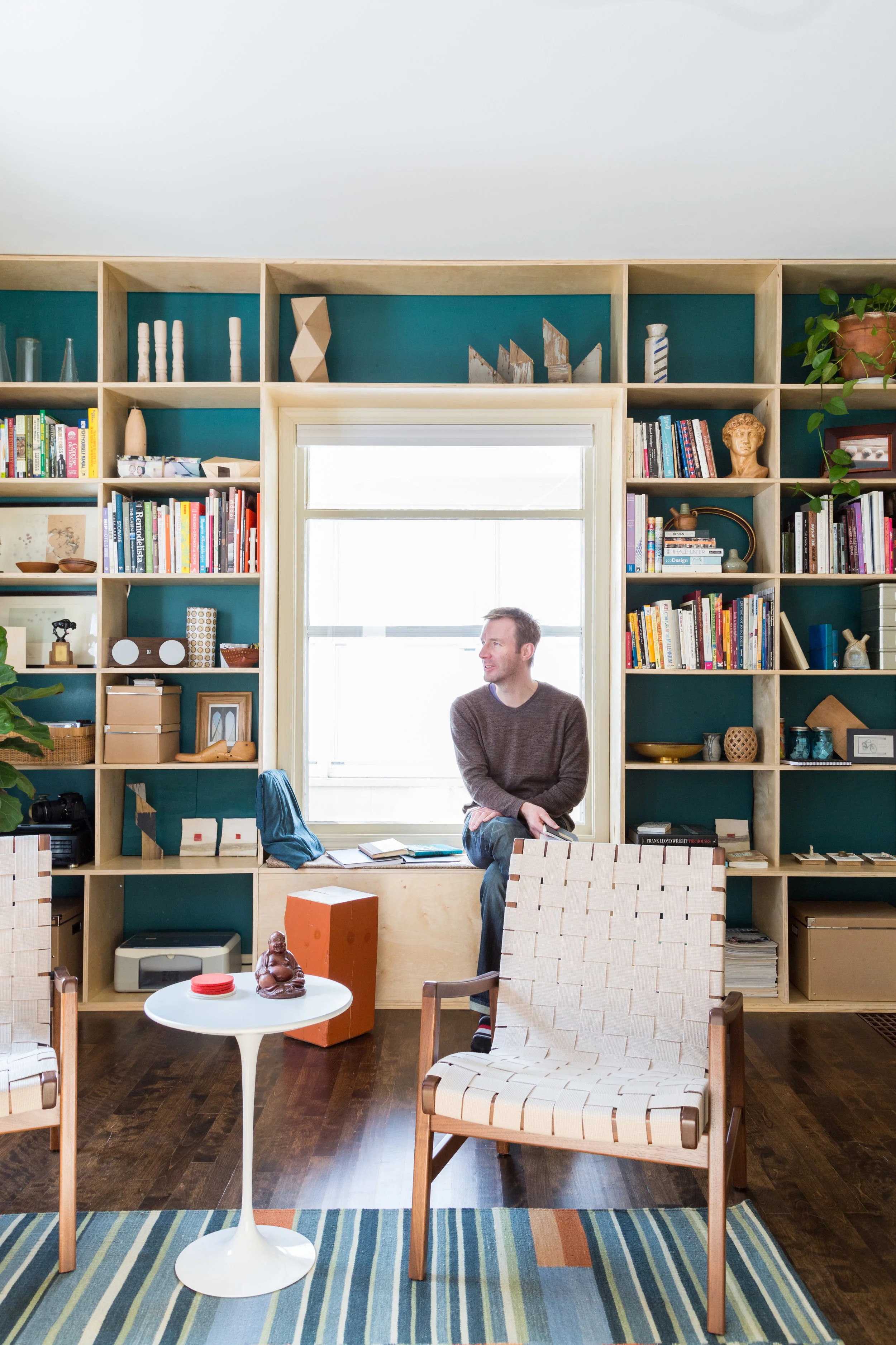 the floor to ceiling bookshelf adds a focal point and adds drama
