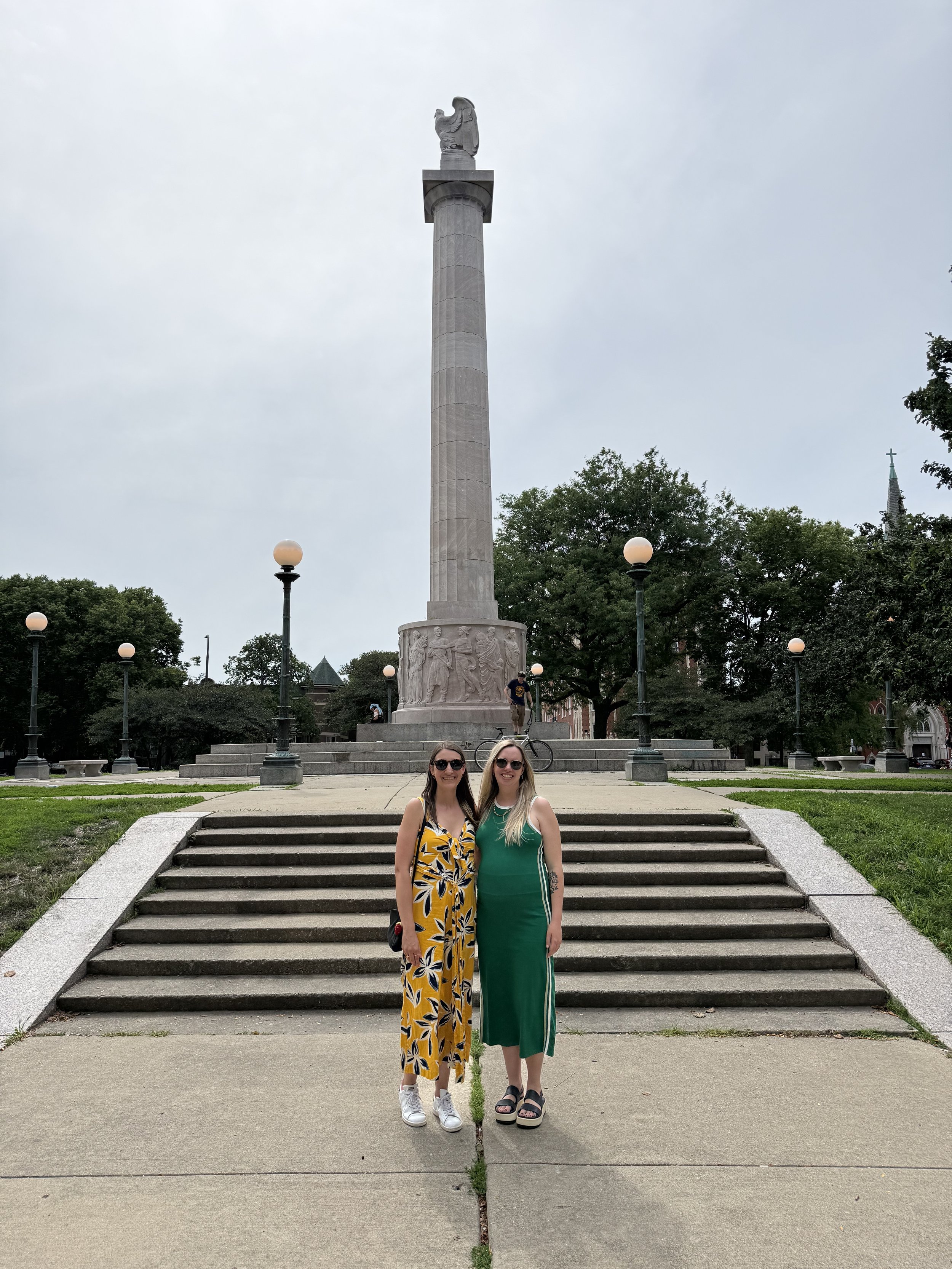 Two women standing in front of Logan Square Monument in Chicago