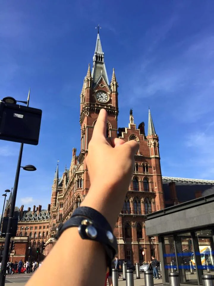 finger pointing to a clock tower in europe during rockamillion epic evangelism