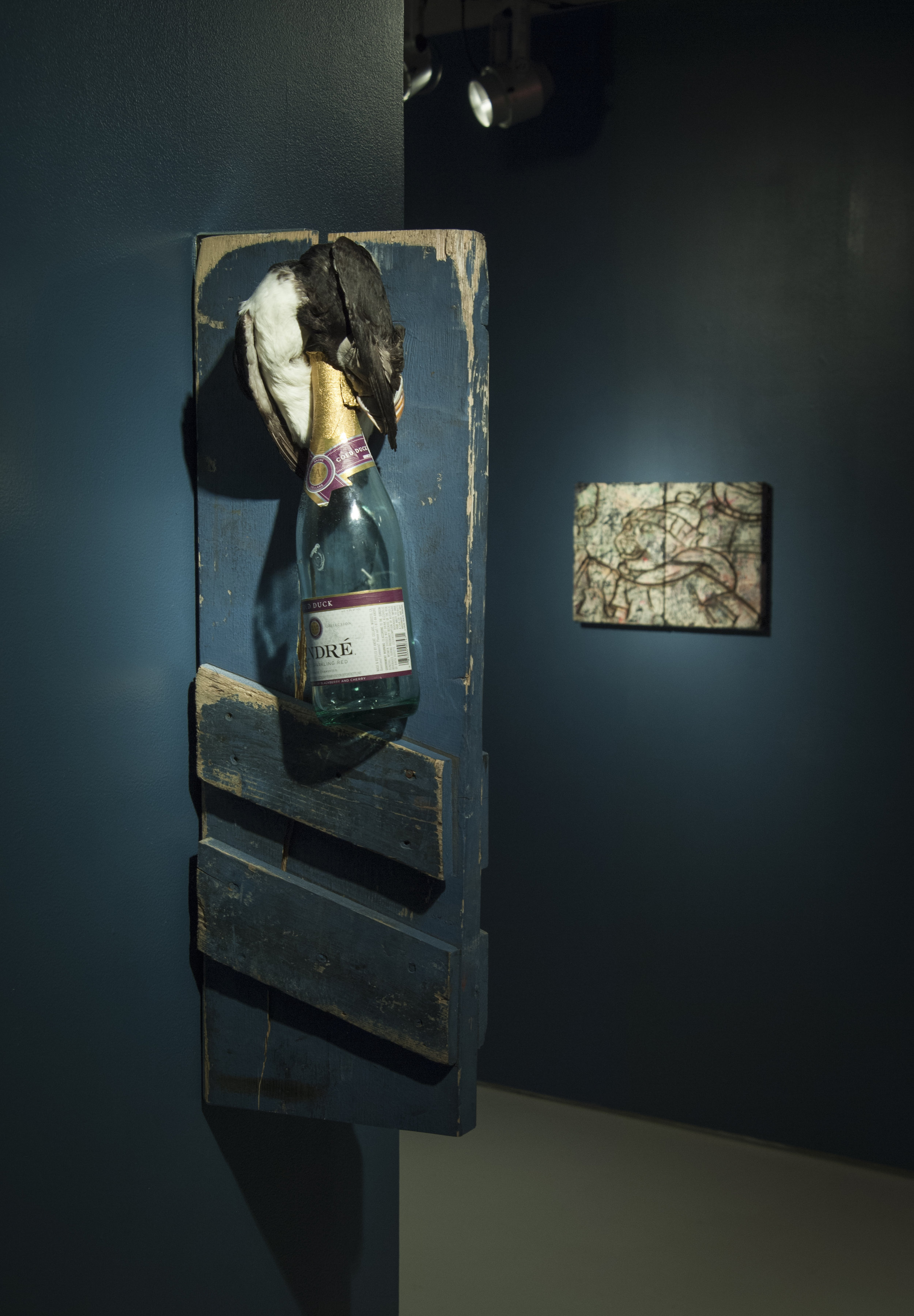 Molotov cocktail , 2016-2017, Cold duck bottle, police barricade, taxidermy bird, 22” x 9” x 5”