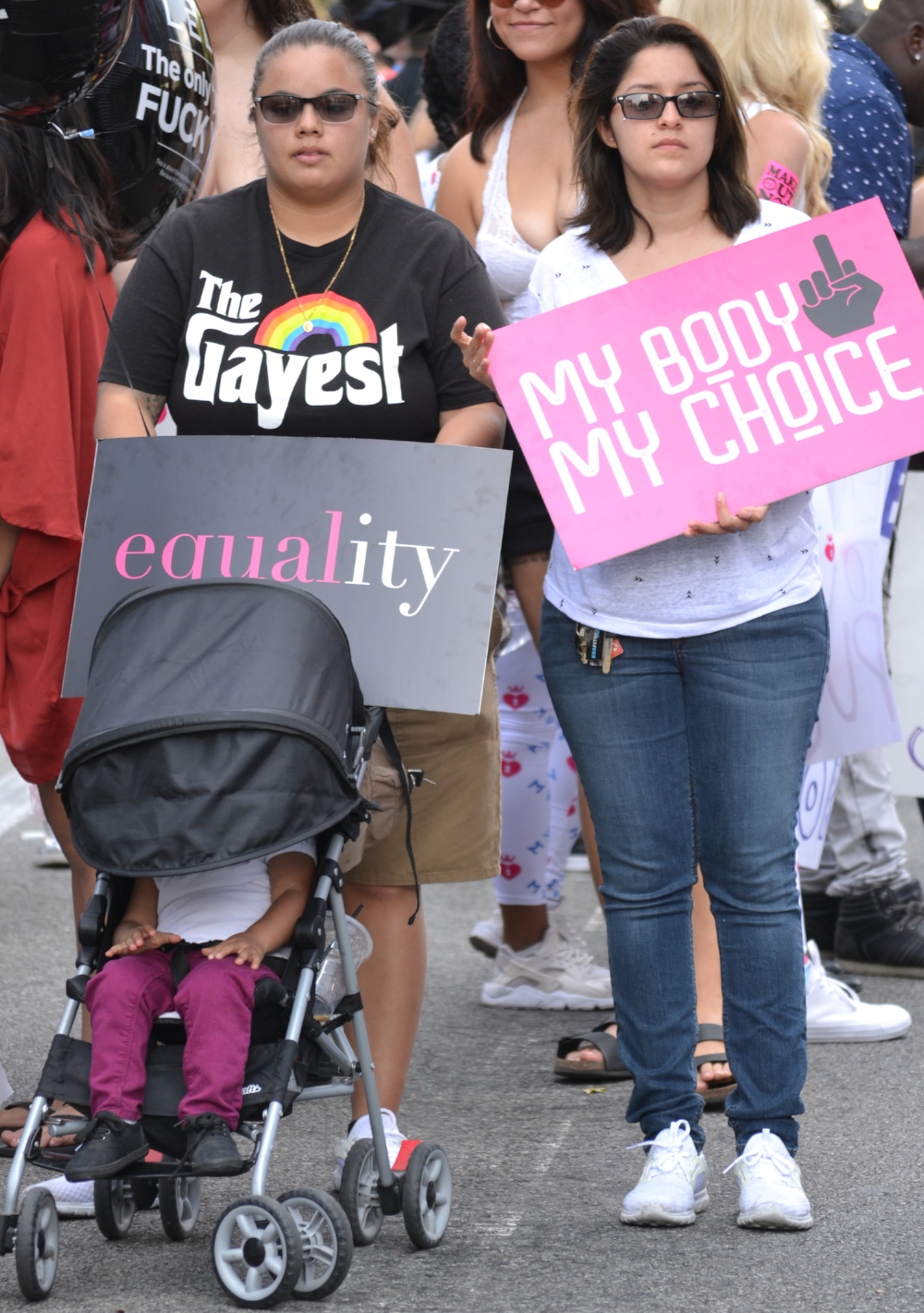 Abigail Gil and Shantrece Williams join the crowds at the 3rd Annual Amber Rose SlutWalk with their 2-year old daughter.