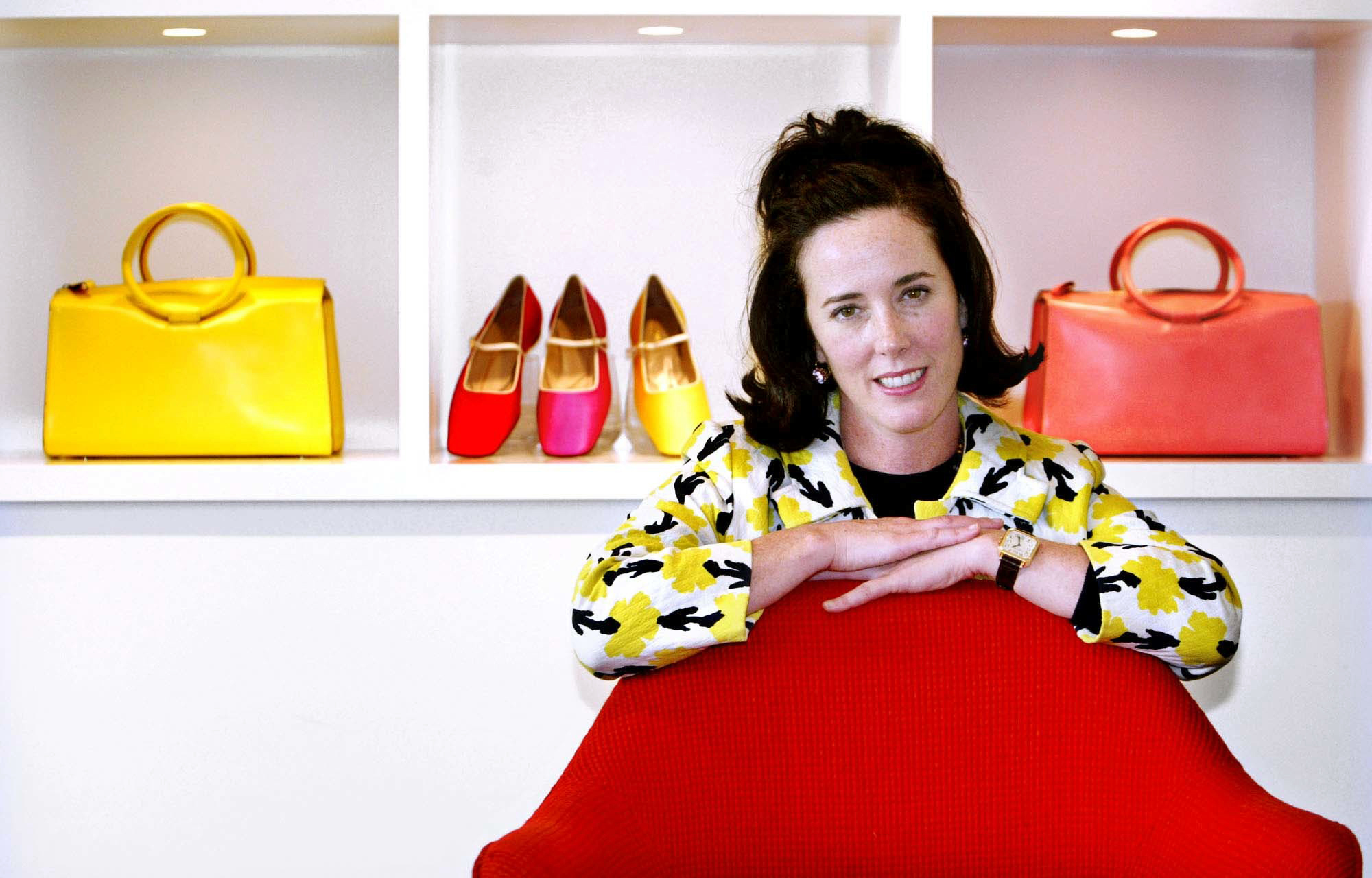 In this May 13, 2004 file photo, designer Kate Spade poses with handbags and shoes from her next collection in New York. Law enforcement officials say Tuesday, June 5, 2018, that New York fashion designer Kate Spade has been found dead in her apartm…