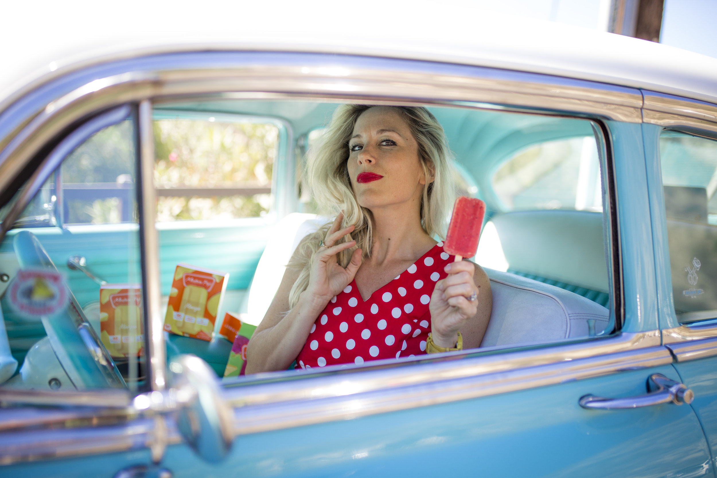 Podolec poses in a 1954 Chevy BelAire Sedan owned by Gil and Bernie Travis, for Mommy In Los Angeles Magazine’s photo shoot in Laguna Beach.
