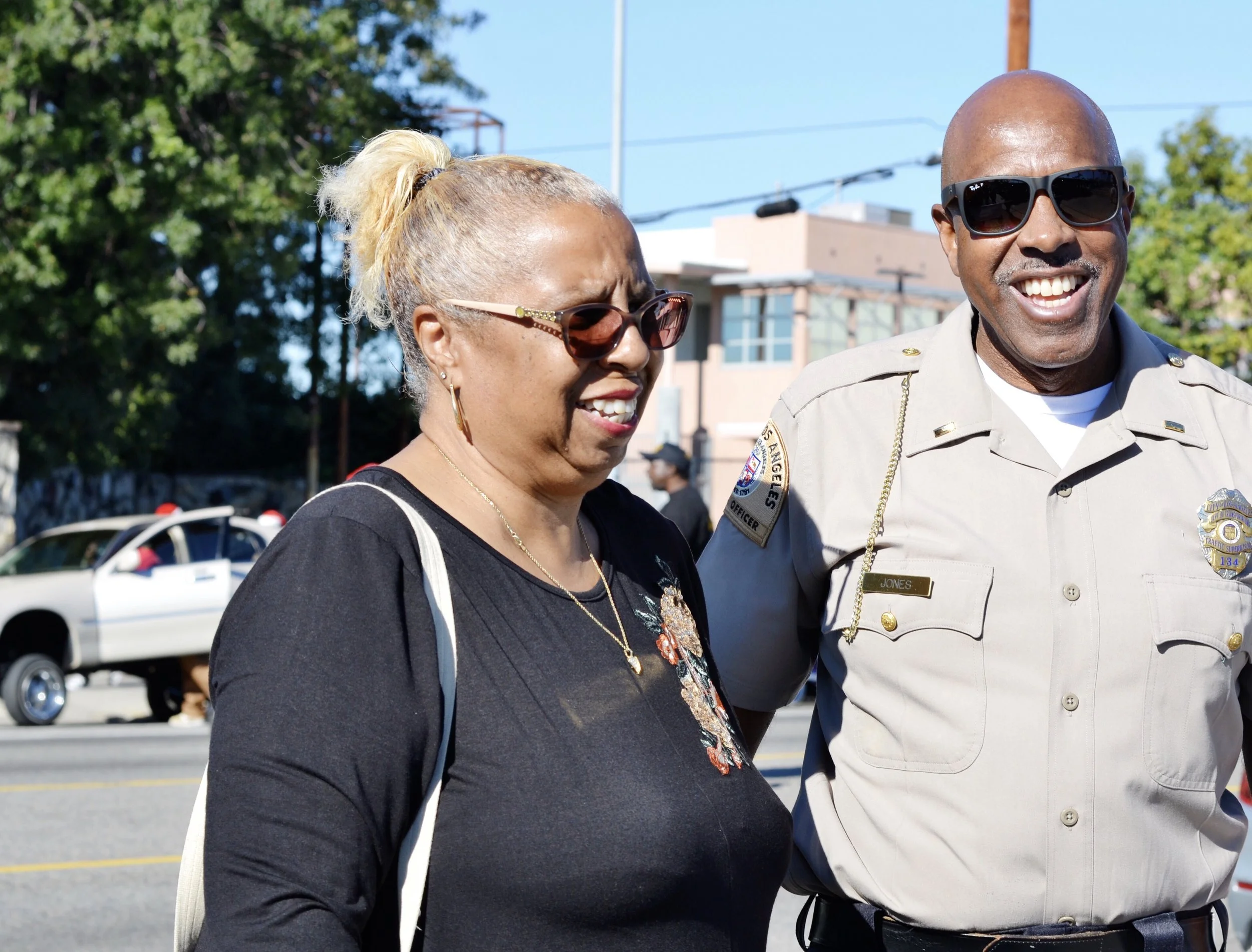 Watts Christmas Parade Organizer, Paula Aliewine discusses last-minute parade details with law enforcement officials. On parade day, “everybody’s happy",” says Aliewine.