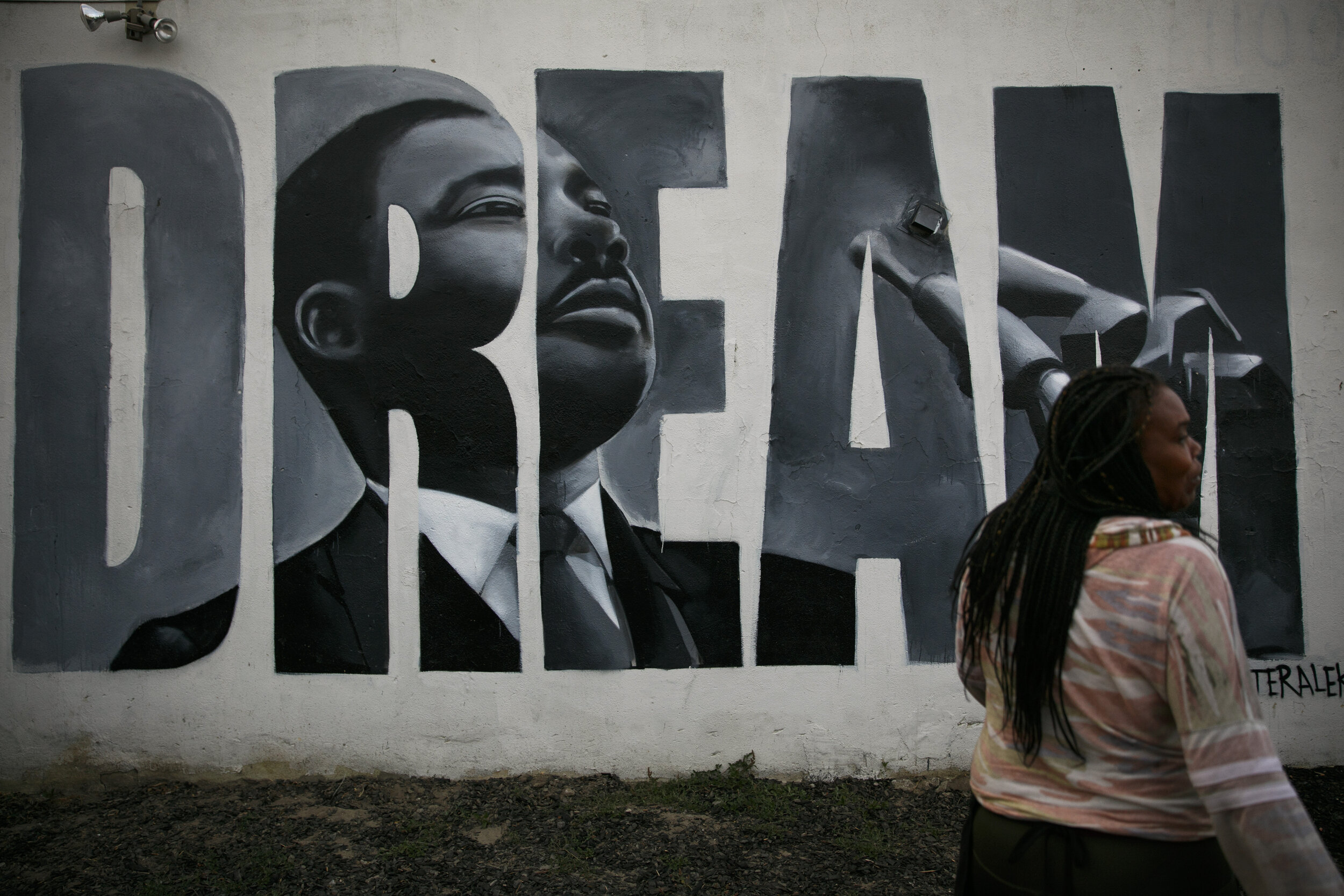  Lorinda Lacy, 45, stands outside her party store painted with a mural depicting Martin Luther King Jr. in the Watts neighborhood of Los Angeles, Tuesday, June 30, 2020. Lacy moved out of Watts 20 years ago because she didn't want her daughters to gr