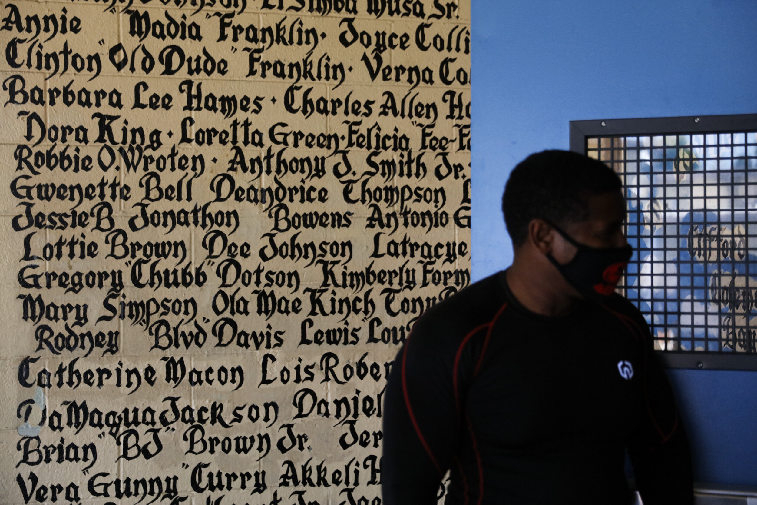  Volunteer Kevin Hunt stands against a wall bearing the names of tenants, who died while living in the Nickerson Gardens housing project, in the Watts neighborhood of Los Angeles, Wednesday, June 10, 2020. (AP Photo/Jae C. Hong) 