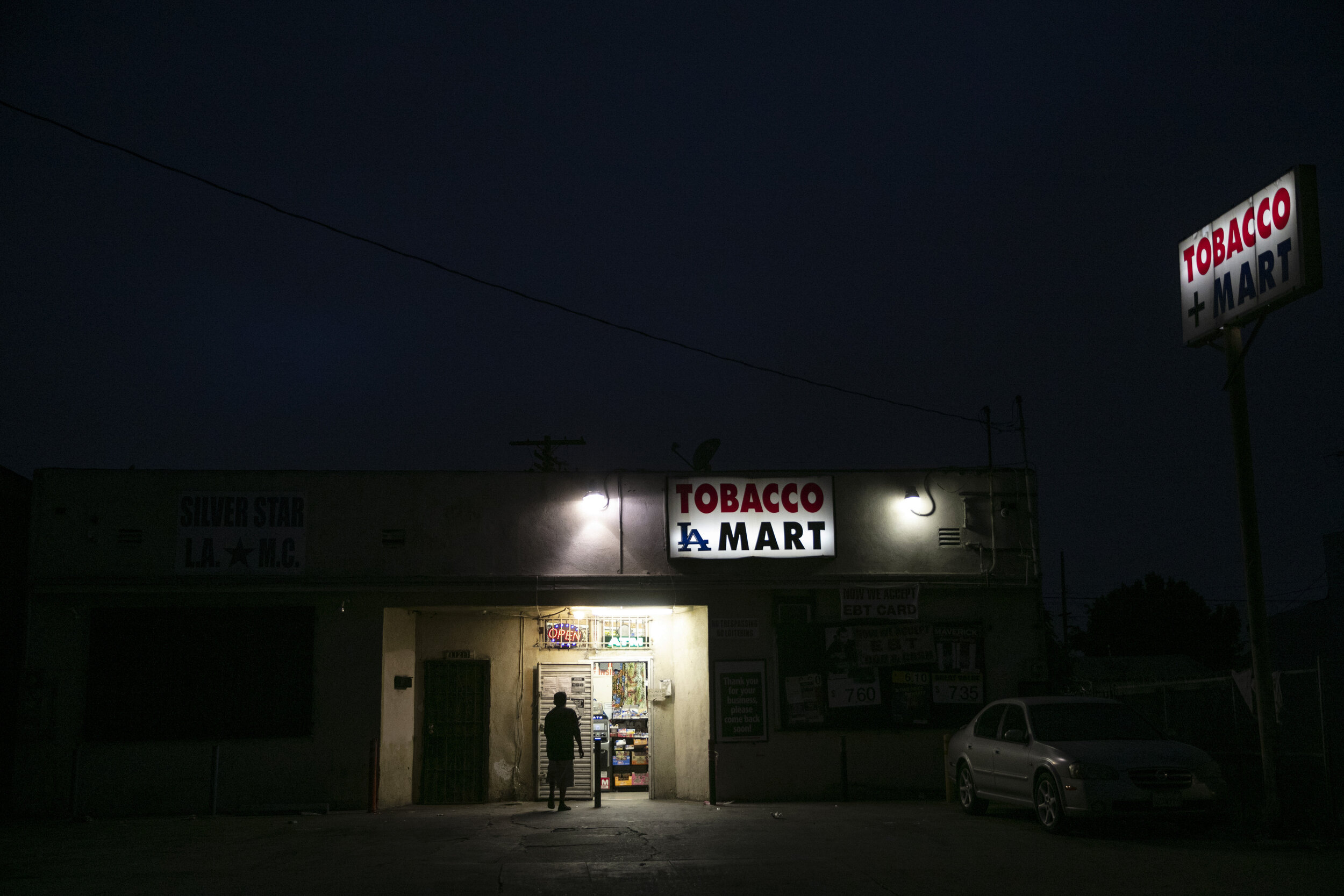  A man walks into a grocery store Tuesday, June 30, 2020, in the Watts neighborhood of Los Angeles. There were no fires this time in Watts. There was no looting, no shooting and no National Guard troops patrolling the streets. When protesters around 