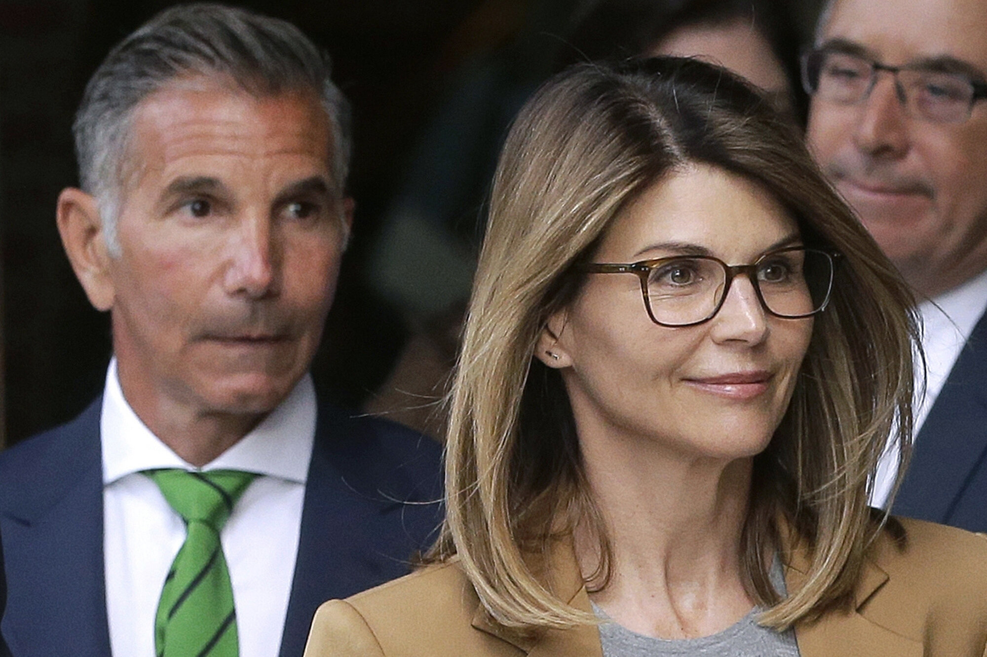 In this April 3, 2019 file photo, actor Lori Loughlin, front, and husband, clothing designer Mossimo Giannulli, left, depart federal court in Boston after facing charges in a nationwide college admissions bribery scandal. Loughlin was released from …