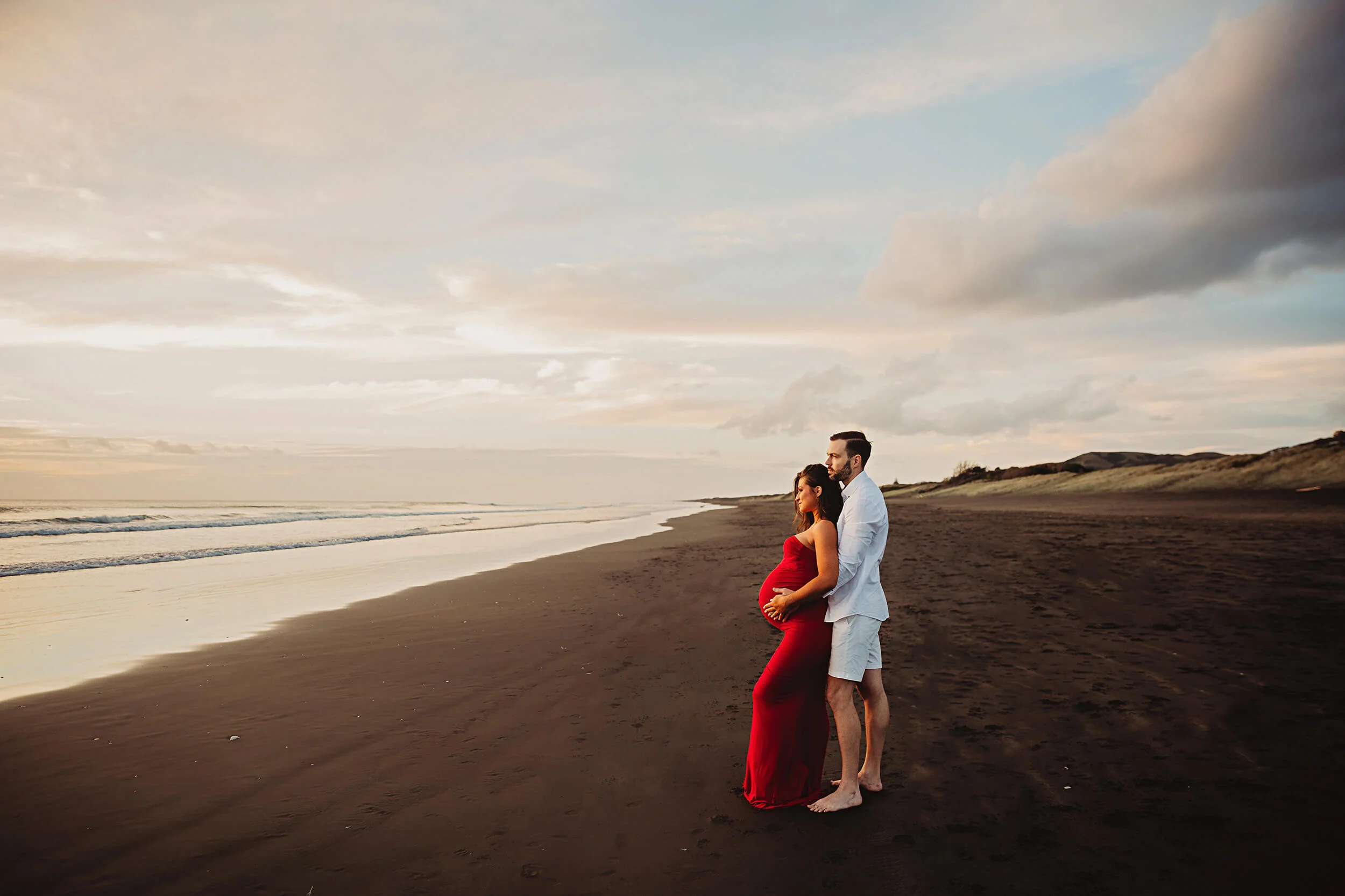Studio maternity session ending with photos under the moon at Muriwai beach
