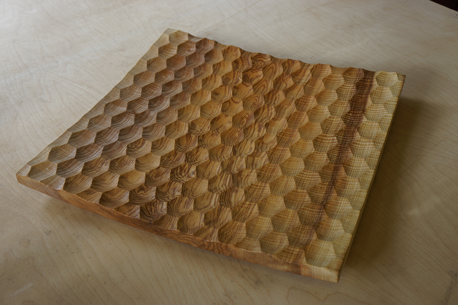 A turned Ash platter with a faceted pattern.