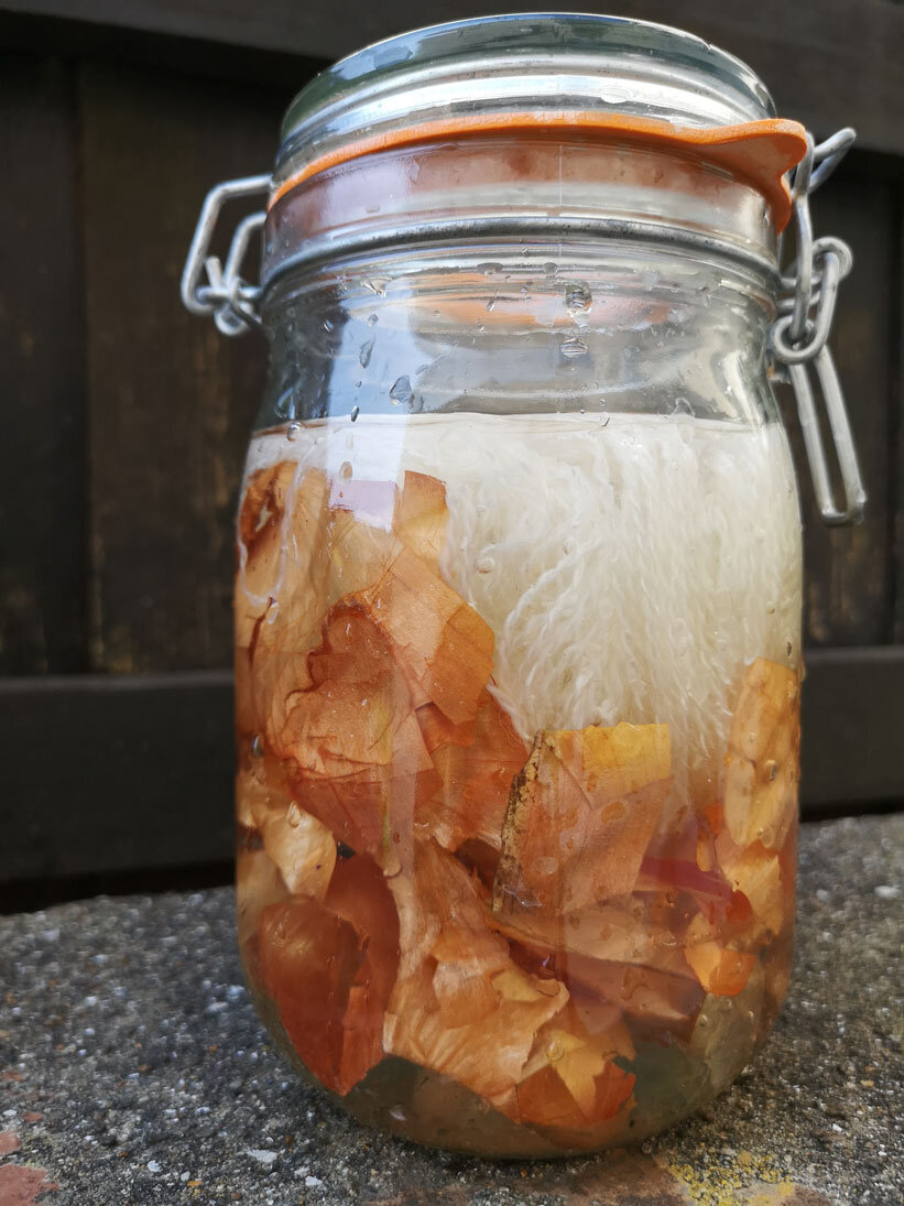 Jar with onion skins, yarn and water