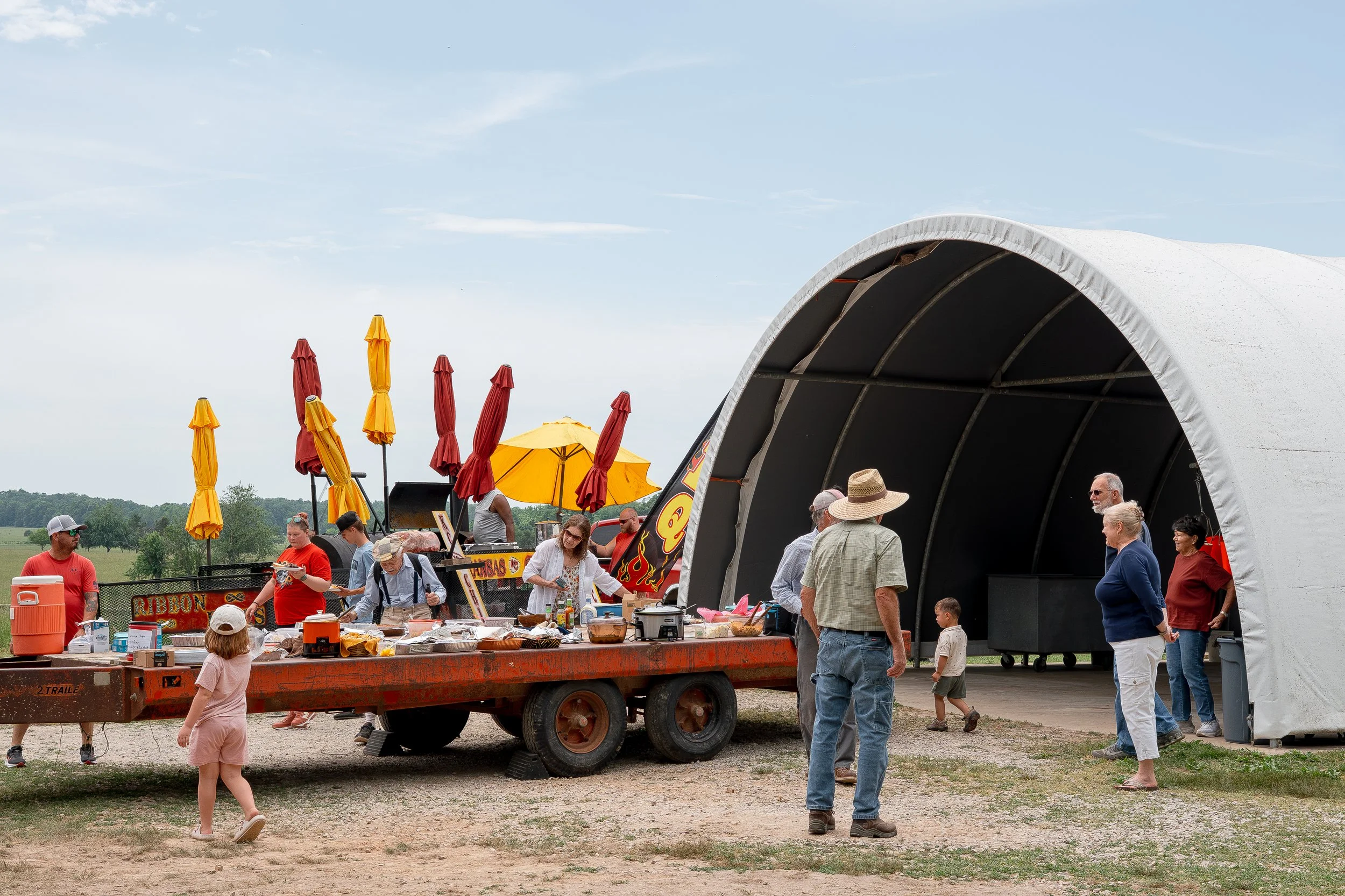 People gathered around a trailer full of food at Farm & Field Day at Peace Valley Poultry