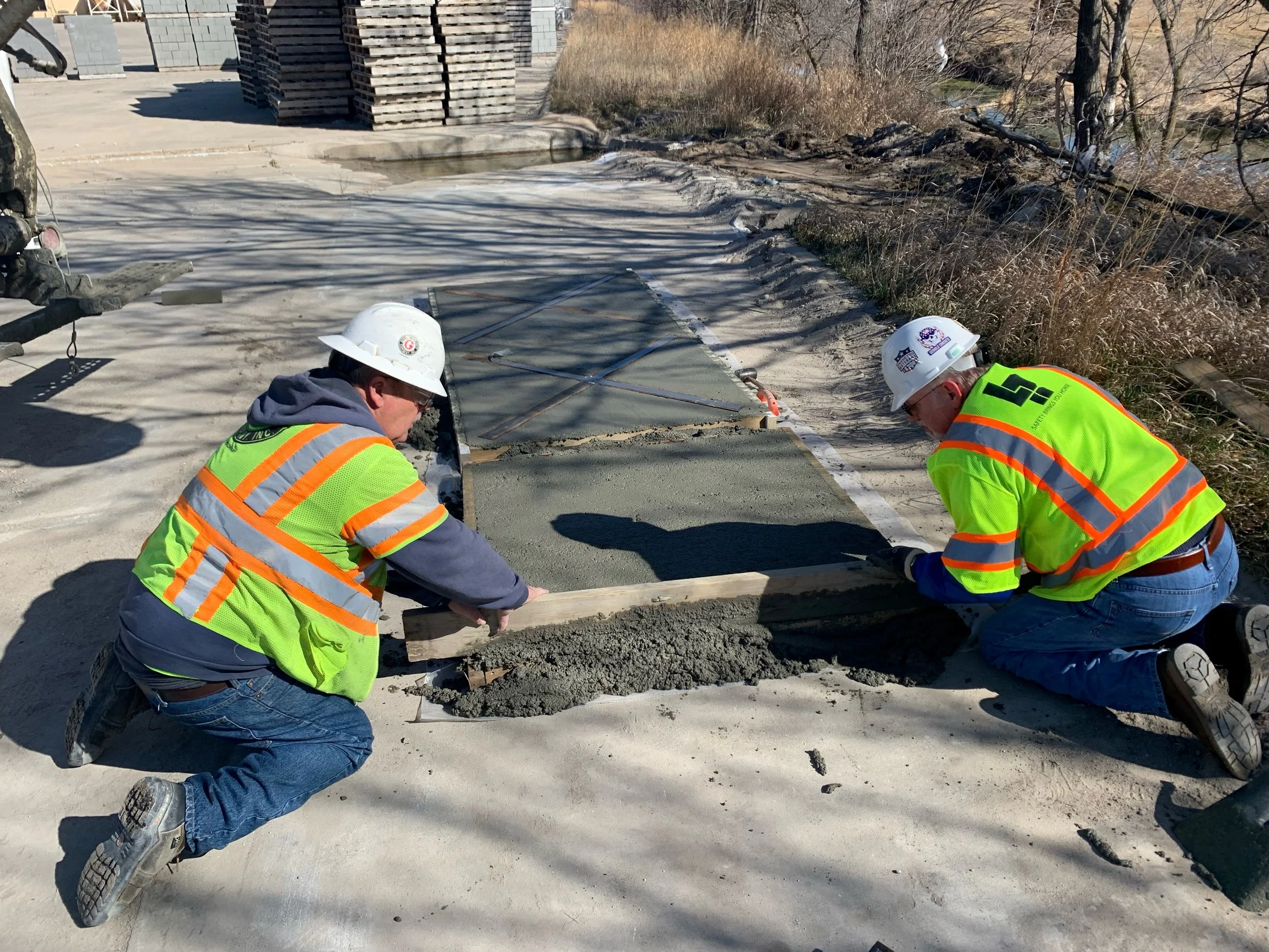 Gerhold Concrete employees Dave Tracy and Dave Keller work on the concrete pads for the Norfolk Sculpture Walk.