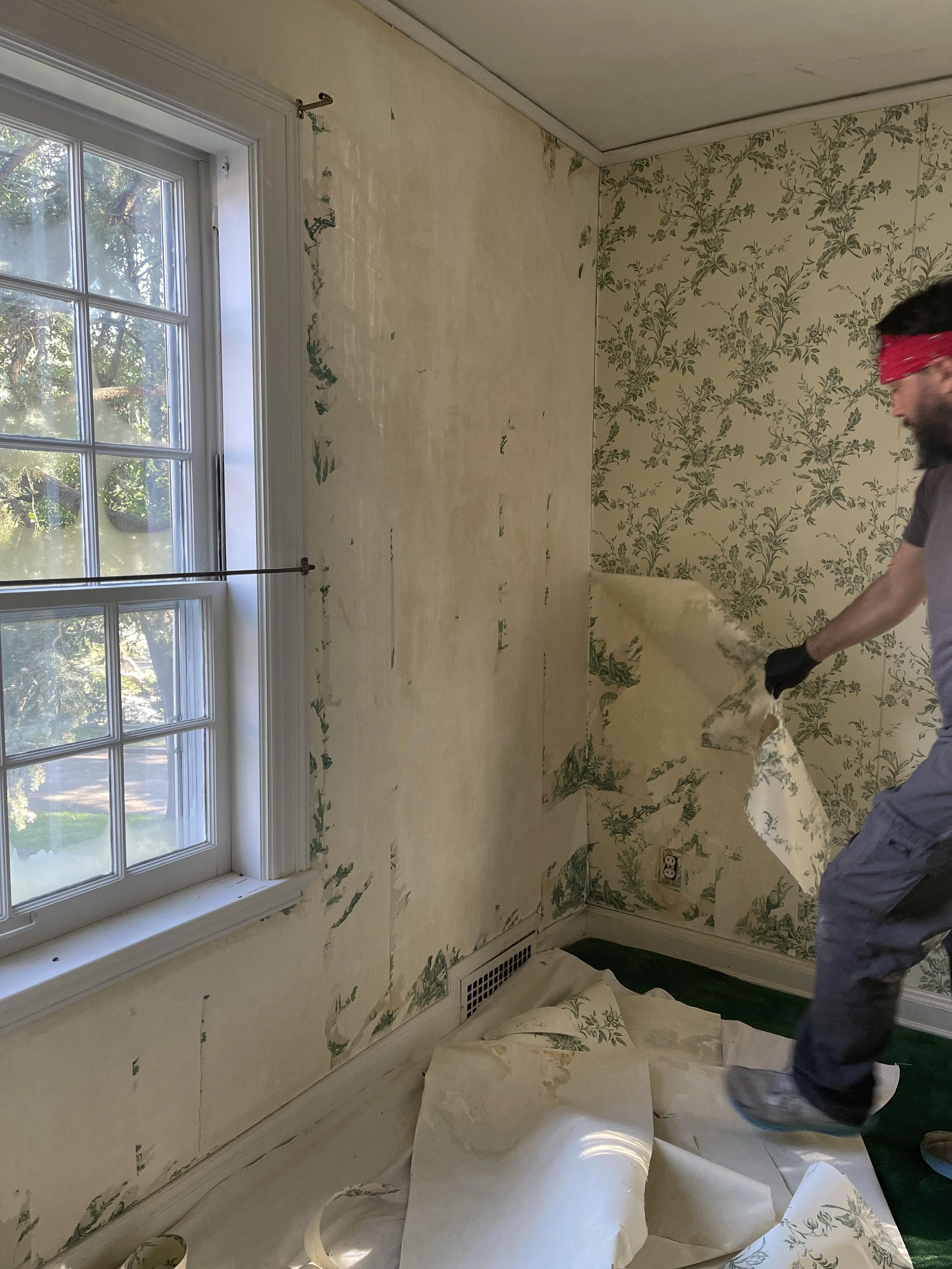 Wallpaper being pulled from the wall in an old home by The Paper Puller