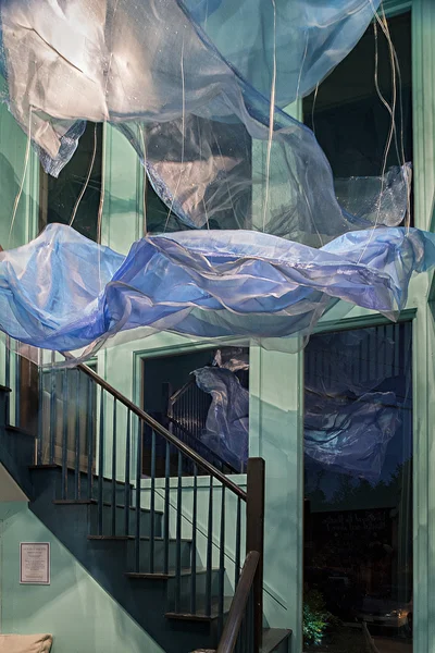 “Ocean Currents” Created by students in Kimberly Collins Jermain’s “Site Specific - Artwork from Proposal to Installation” course at Endicott College. This installation was designed to transform a restaurant vestibule waiting area located at the bottom of a two-story stairwell into an underwater realm. Materials: Fabric, Wire, Aluminum, Window Mesh