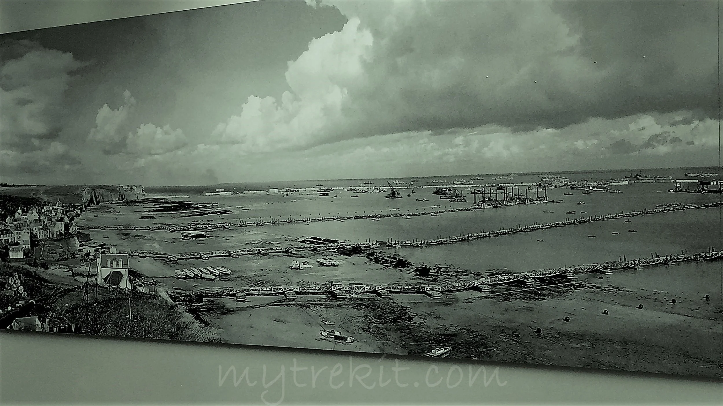 a view of military operations, including the famous 'mulberrys' used to transport land vehicles to shore at Arromanche (Gold Beach), June 1944. The mulberrys, or artificial harbors, were the brainchild of winston churchill, built by British engineers, and considered to be one of the greatest military achievements. 
