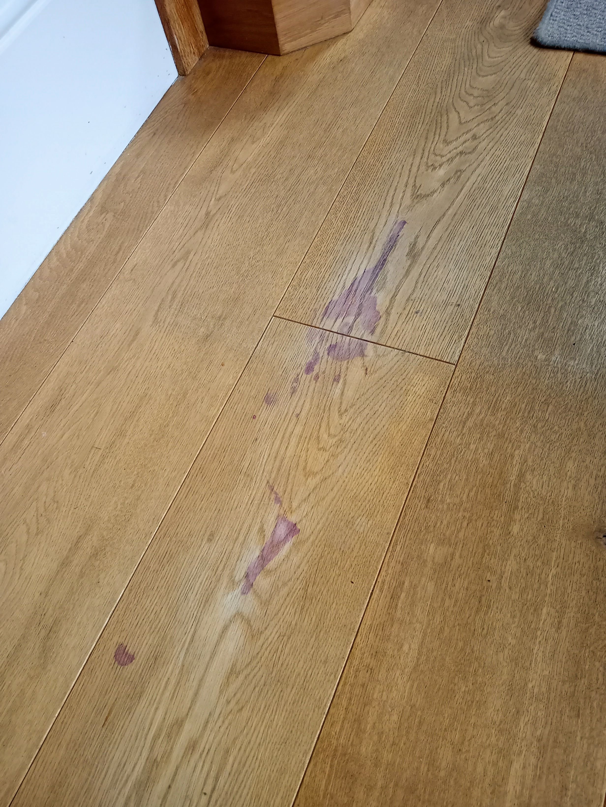 A wine stain on a wooden floor