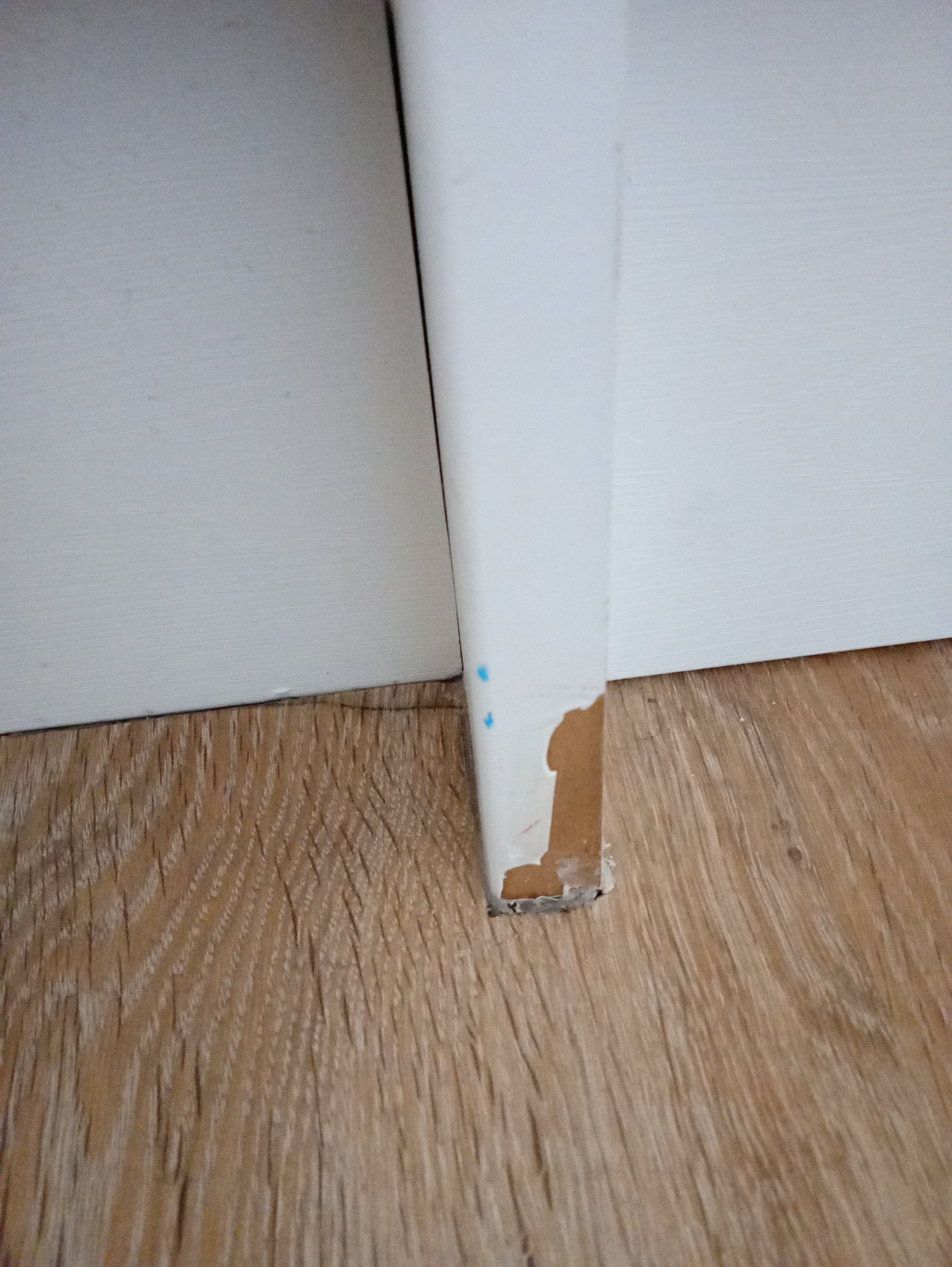 A damaged kitchen unit panel