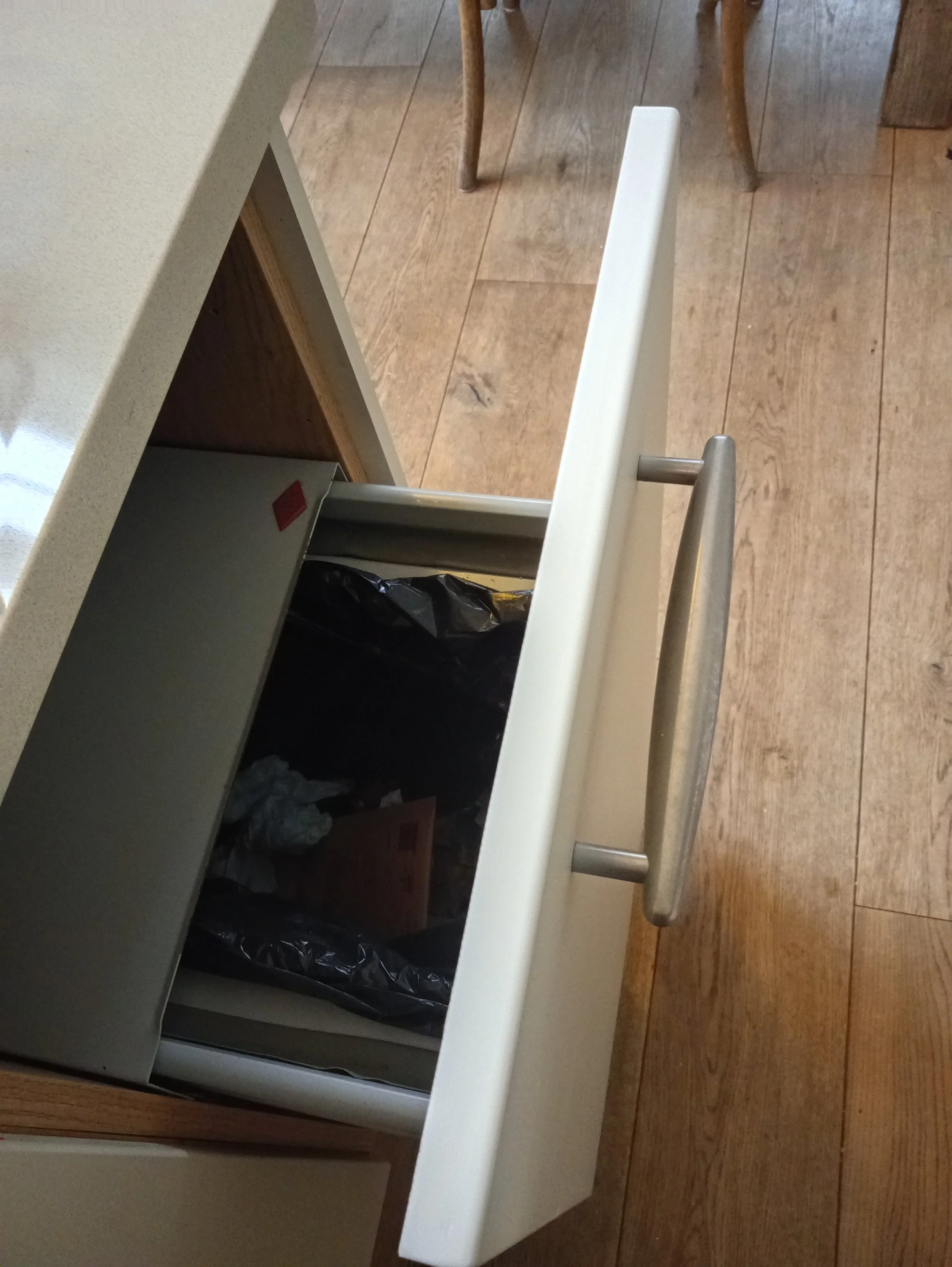 Open kitchen drawer with surface covering repaired