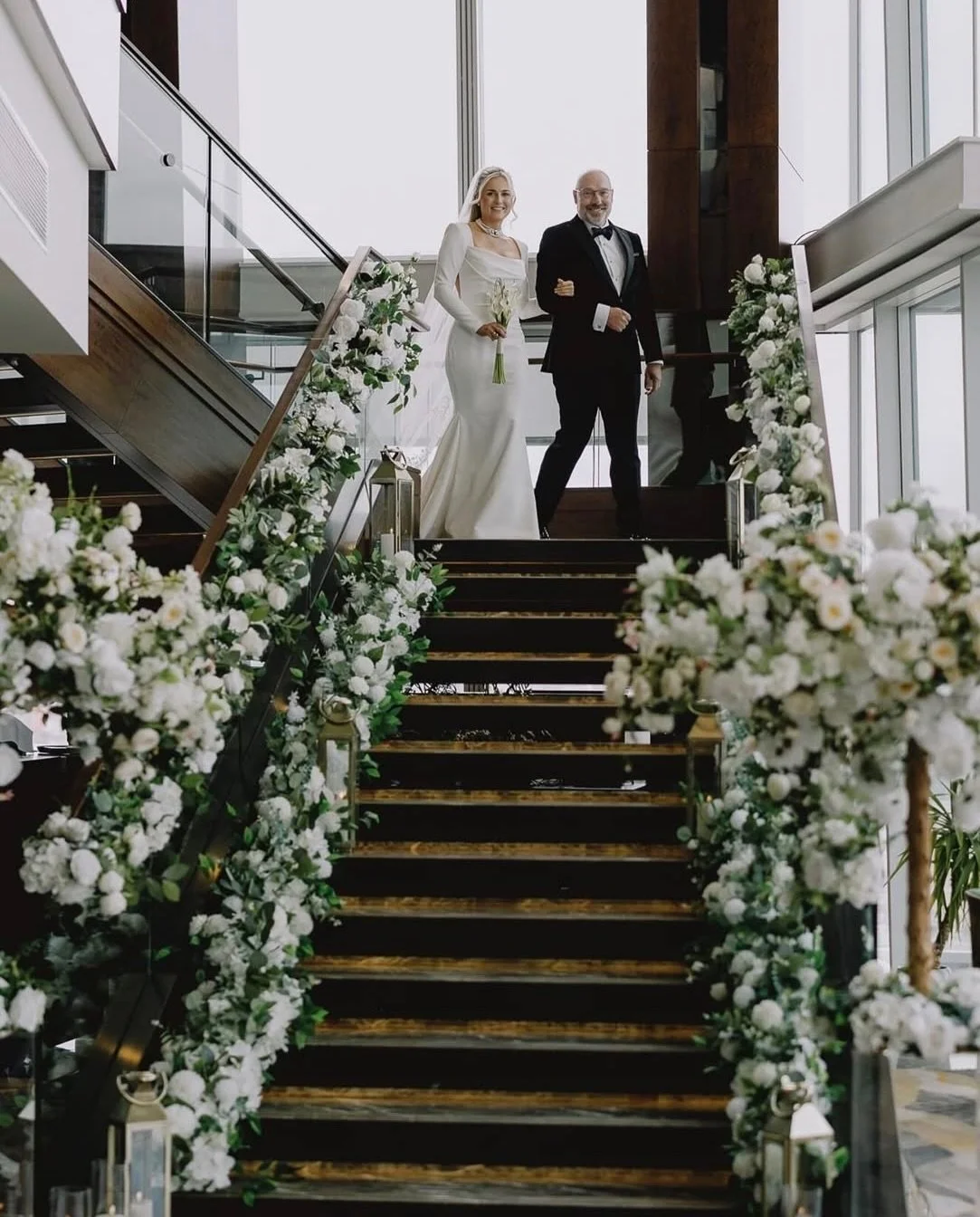 Grand floral staircase arrangement at Shangri-La Hotel, London, styled with lush greenery and white blooms by Diamond Lush Events.