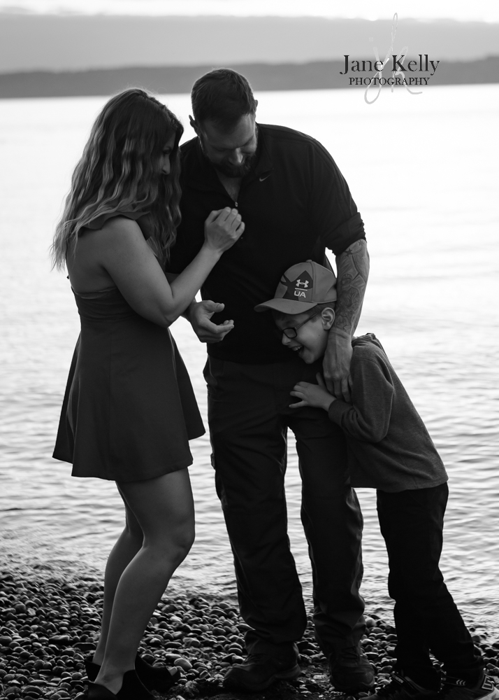 candid family laughing beachside in snohomish county