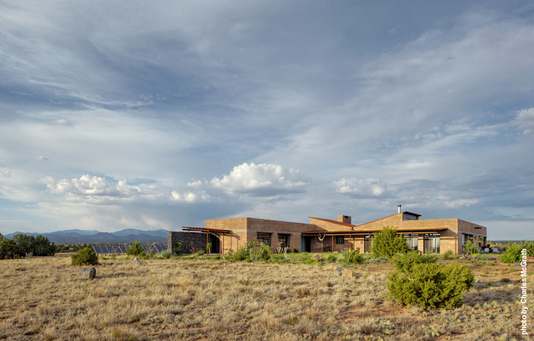 The Applewhite Home in New Moon Overlook uses passive and active solar strategies to generate more electricity than it uses. Rain collection and black-water-treatment systems save on domestic water use and support extensive xeric landscaping.