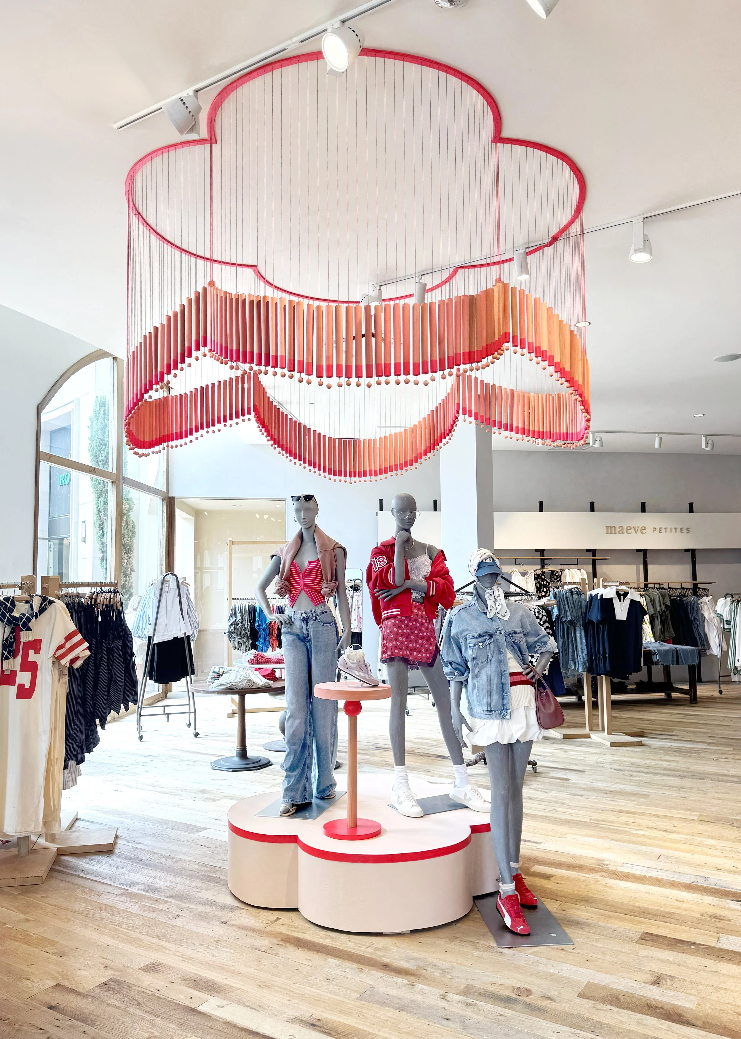    Anthropologie Fall ‘25 Interiors:    Clover shaped chime installation. Made from painted wooden dowels and beads. Matching riser and table built  to accompany  hanging piece. 