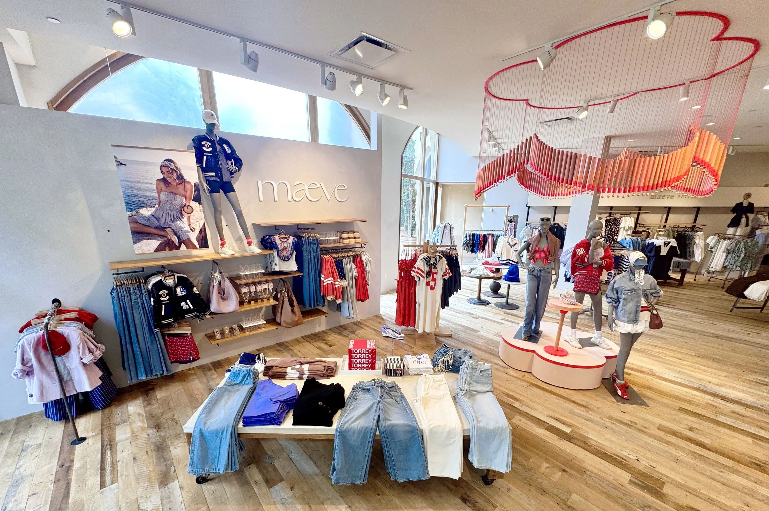    Anthropologie Fall ‘25 Interiors:    Clover shaped chime installation. Made from painted wooden dowels and beads. Matching riser and table built  to accompany  hanging piece. 