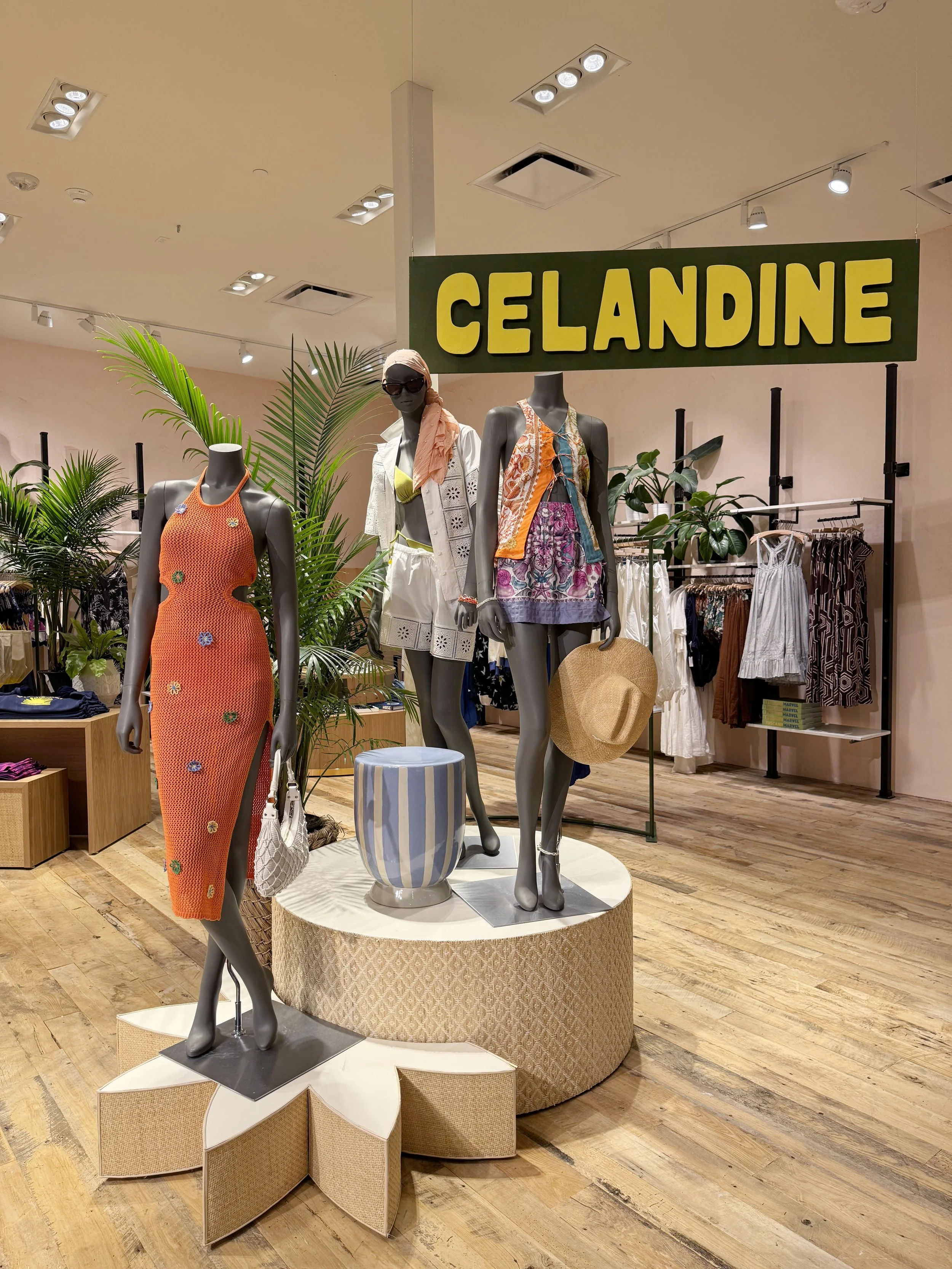    Anthropologie Fall ‘25 Interiors:    Custom star shaped and round nesting mannequin stands, wrapped in rattan. Accompanied by wooden hanging sign. 