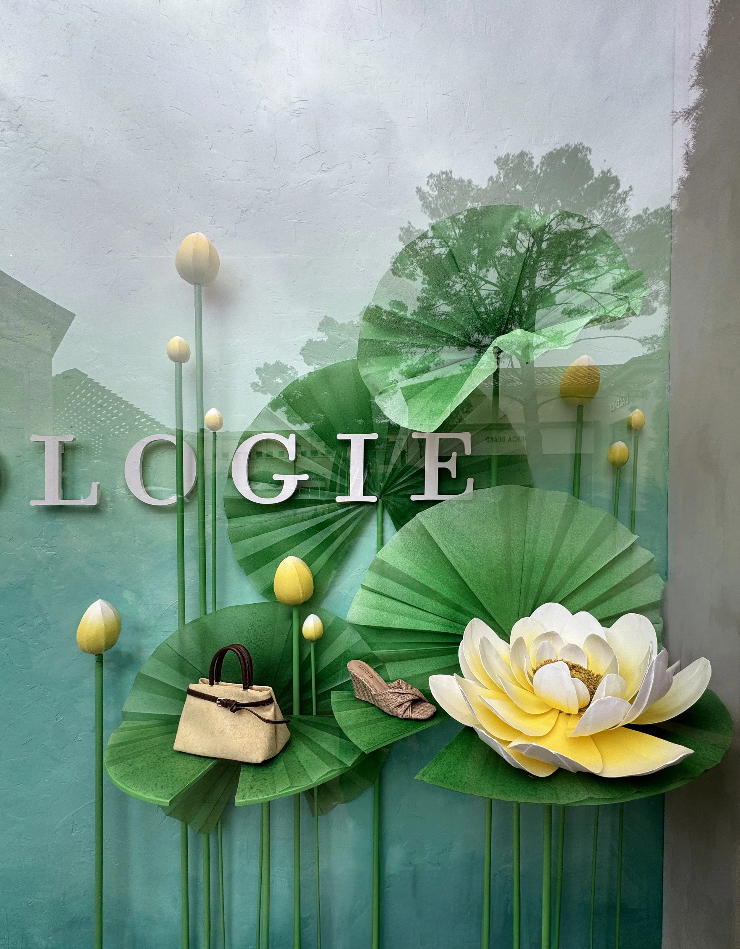    Anthropologie Spring ‘26 Window:    Oversized lily pads made from buckram and duralar, lotus flowers made from chipboard and plaster. 
