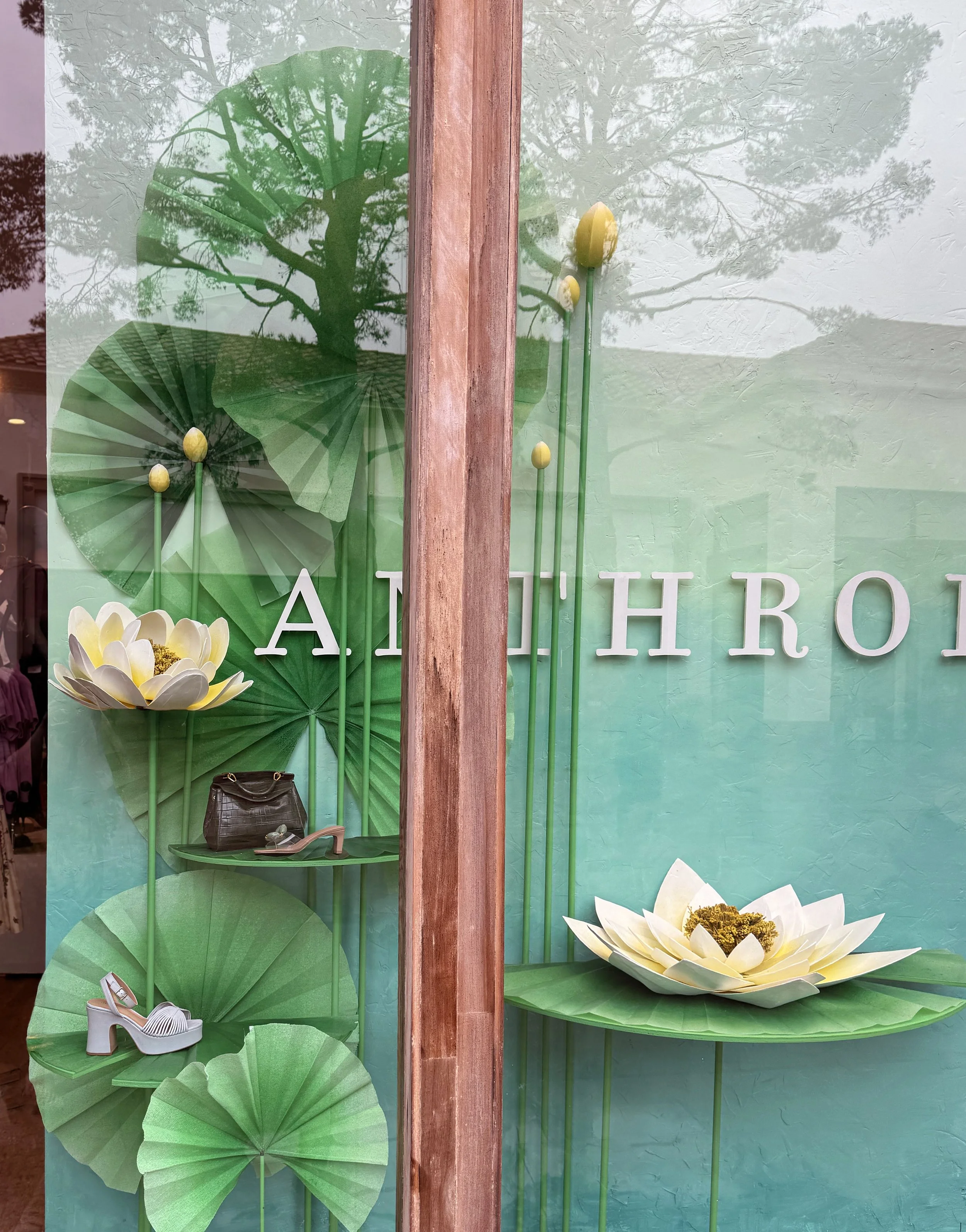    Anthropologie Spring ‘26 Window:    Oversized lily pads made from buckram and duralar, lotus flowers made from chipboard and plaster. 