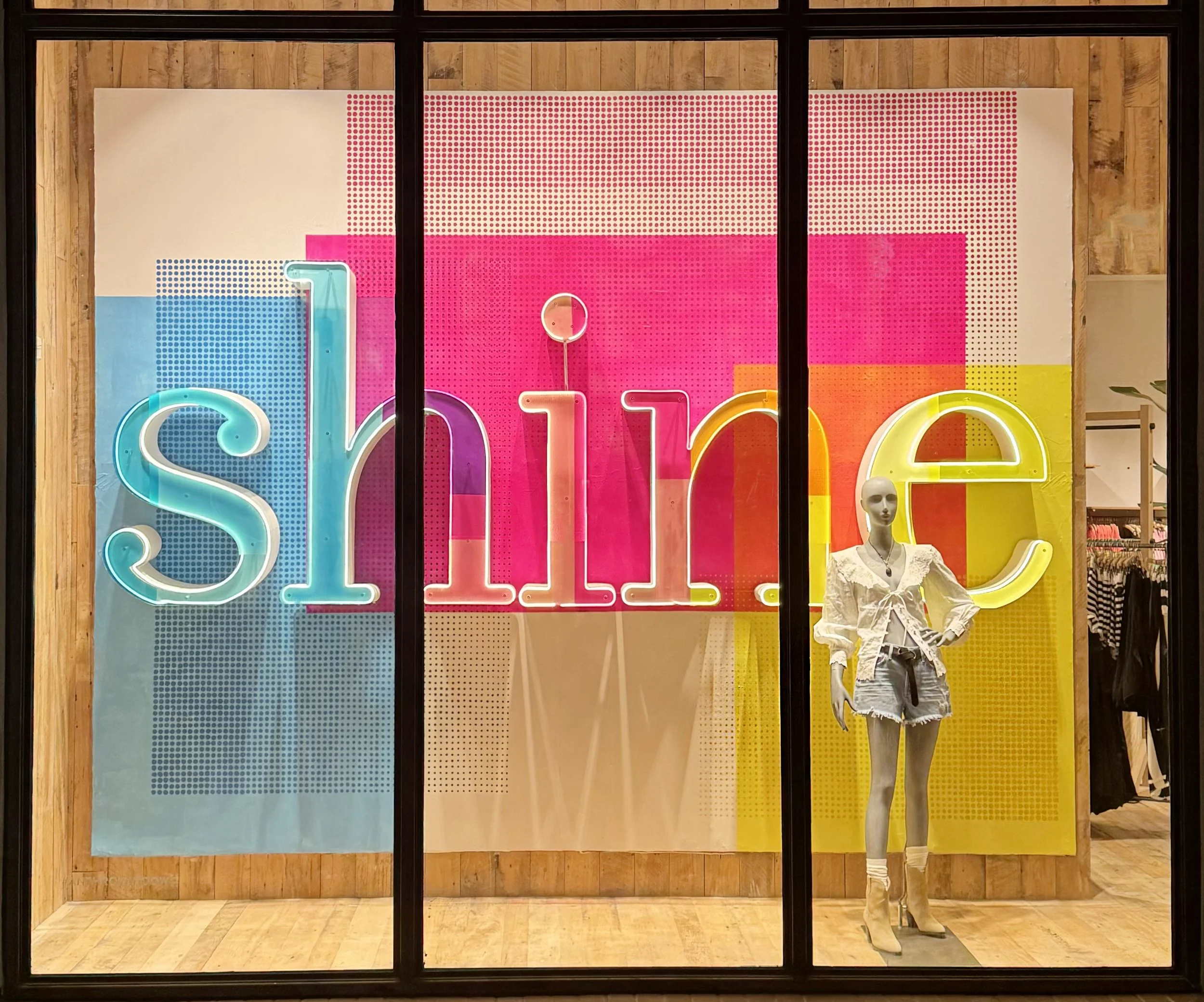    Anthropologie Summer ‘24 Window:    ‘Shine’ letters made from wood, layered with plexi top and lit underneath. Plexi is painted and coated in layers of colored vinyls. Wall painted by hand and with a hand-punched stamp. 