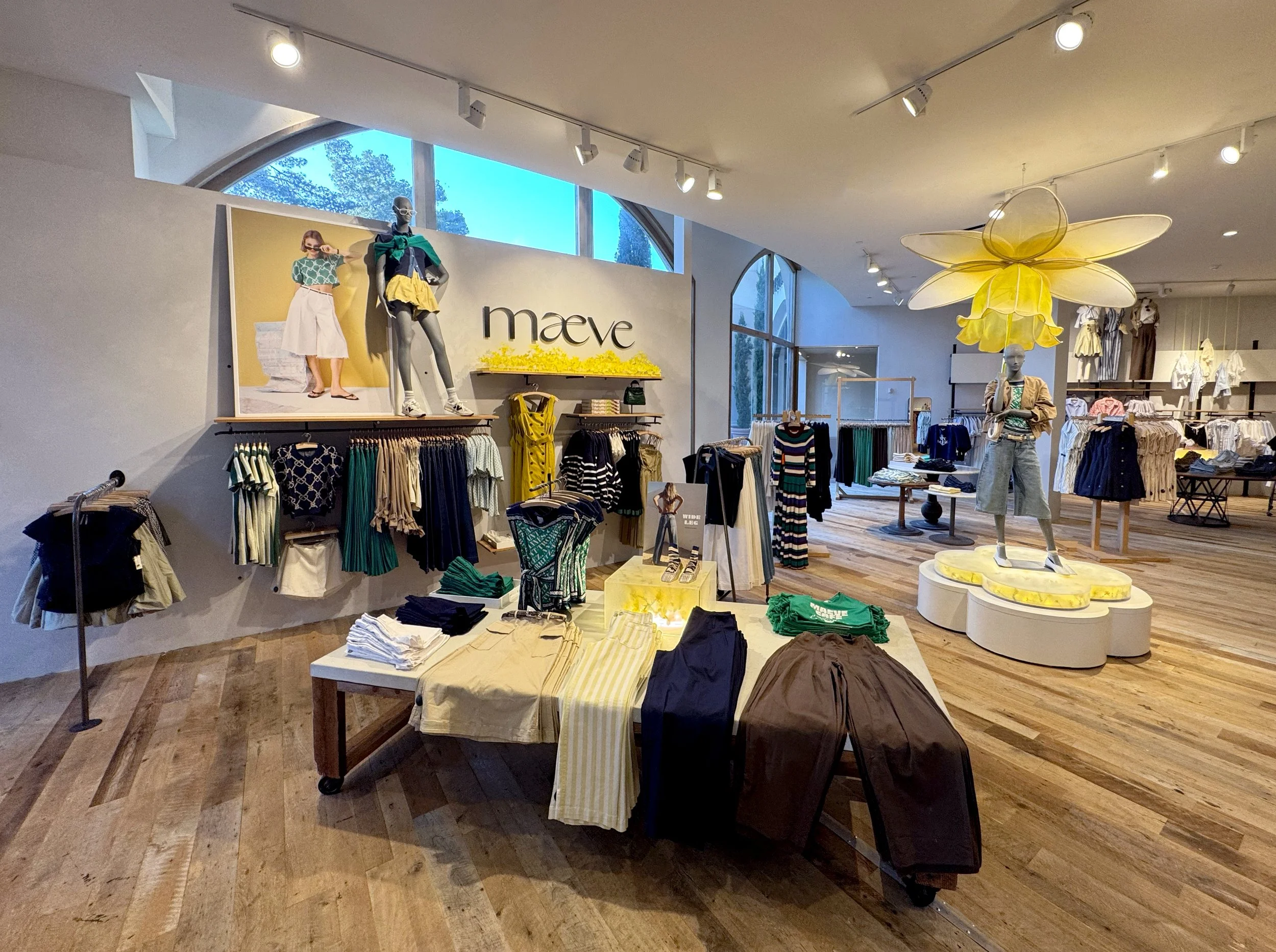    Anthropologie Spring ‘26 Interiors:    Daffodil umbrella made from painted silk screen, and soaked reed. Lit frosted risers, filled with hand dyed flowers . 