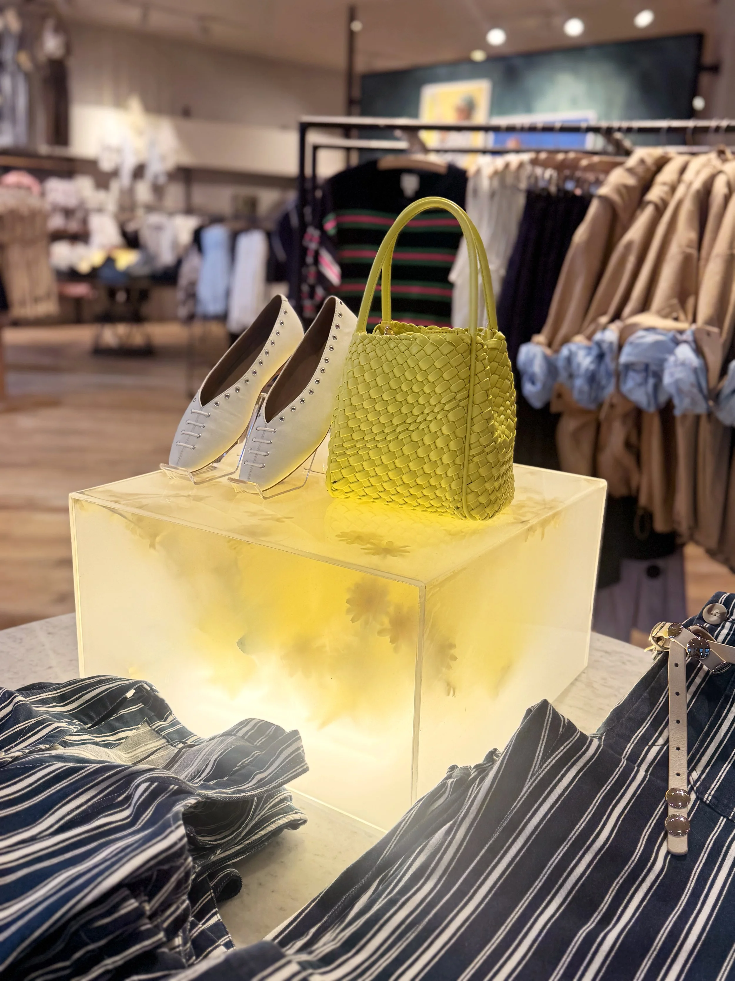    Anthropologie Spring ‘26 Interiors:    Daffodil umbrella made from painted silk screen, and soaked reed. Lit frosted risers, filled with hand dyed flowers . 