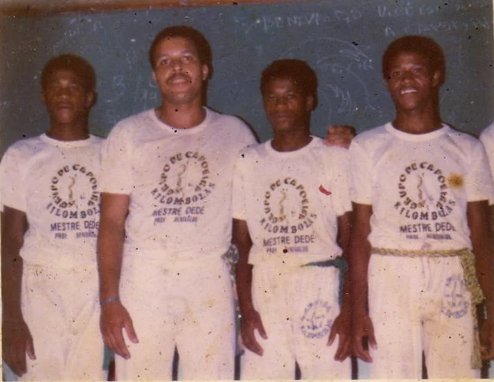 A young Mestre Bomba, far left, with Mestre Benivaldo, second from left, as members of Mestre Dede’s Grupo Quilombola, the “grandfather” group of Capoeira Barro Vermelho, in Salvador, Bahia Brazil.