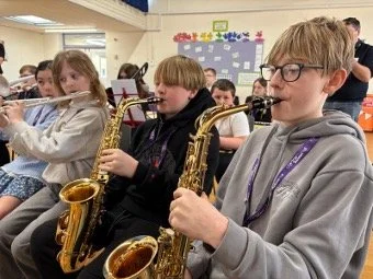 Children playing saxaphone.jpg
