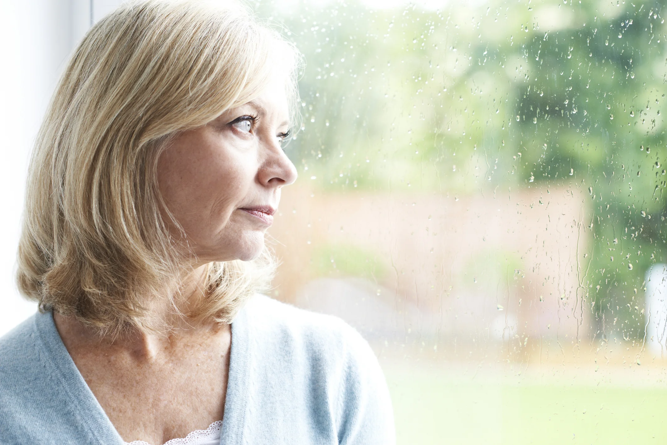 woman-in-her-50s-looking-out-the-window_gettyimages-543048812.jpg