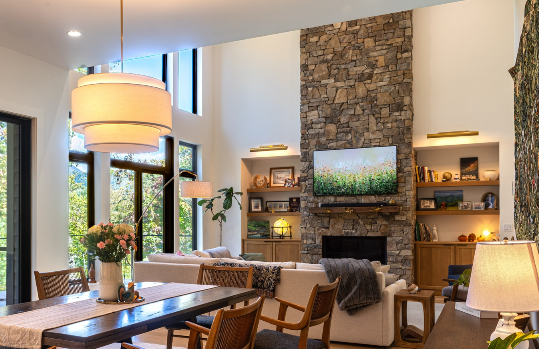 Stone fireplace with visible hearth flanked by armchairs in a living room