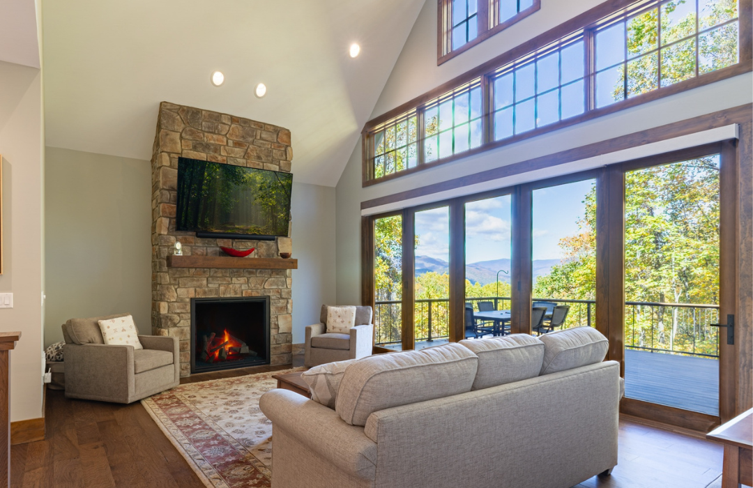 Stone fireplace with visible hearth flanked by armchairs in a living room
