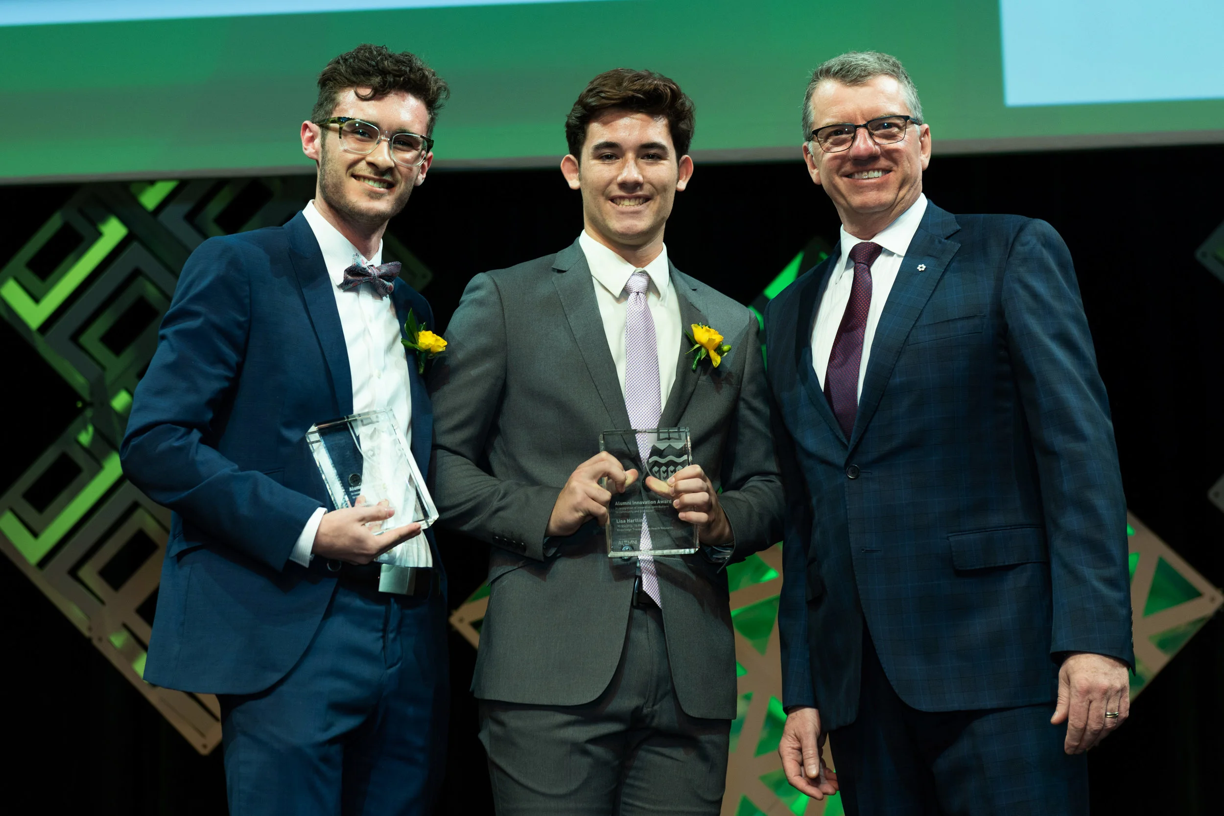 The children of Drs. Scott and Hartling collecting the University of Alberta 2018 Alumni Innovator of the Year Award, on their behalf.