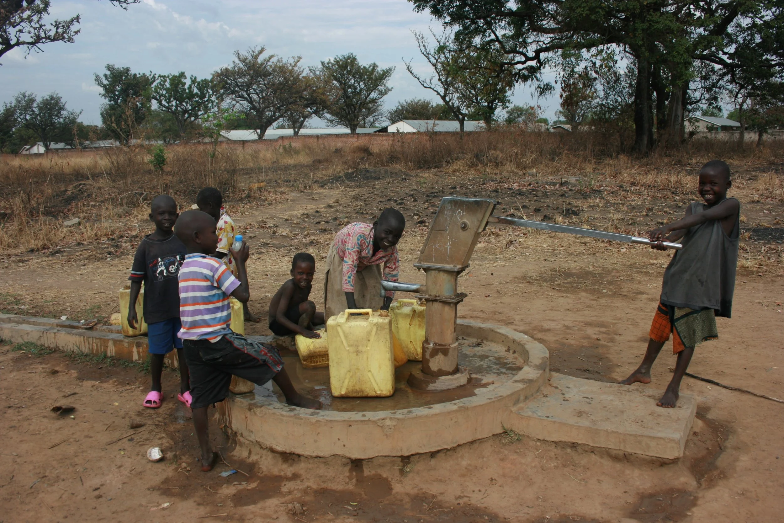 Kids helping to pump water. 